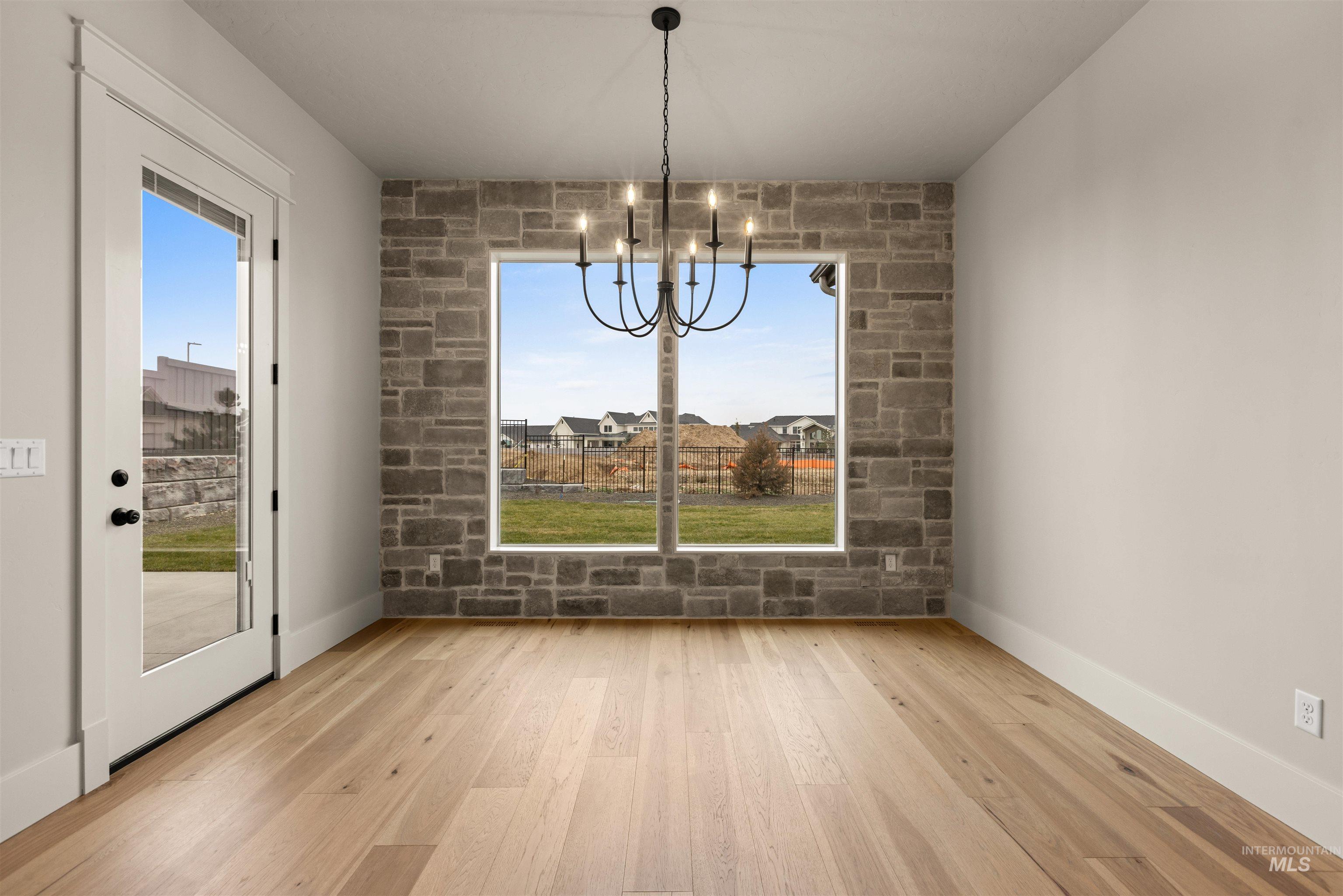 6844 South Messner Way Meridian, ID 83642 - Photo 20 of 49 Unfurnished dining area with light wood-type flooring and a chandelier