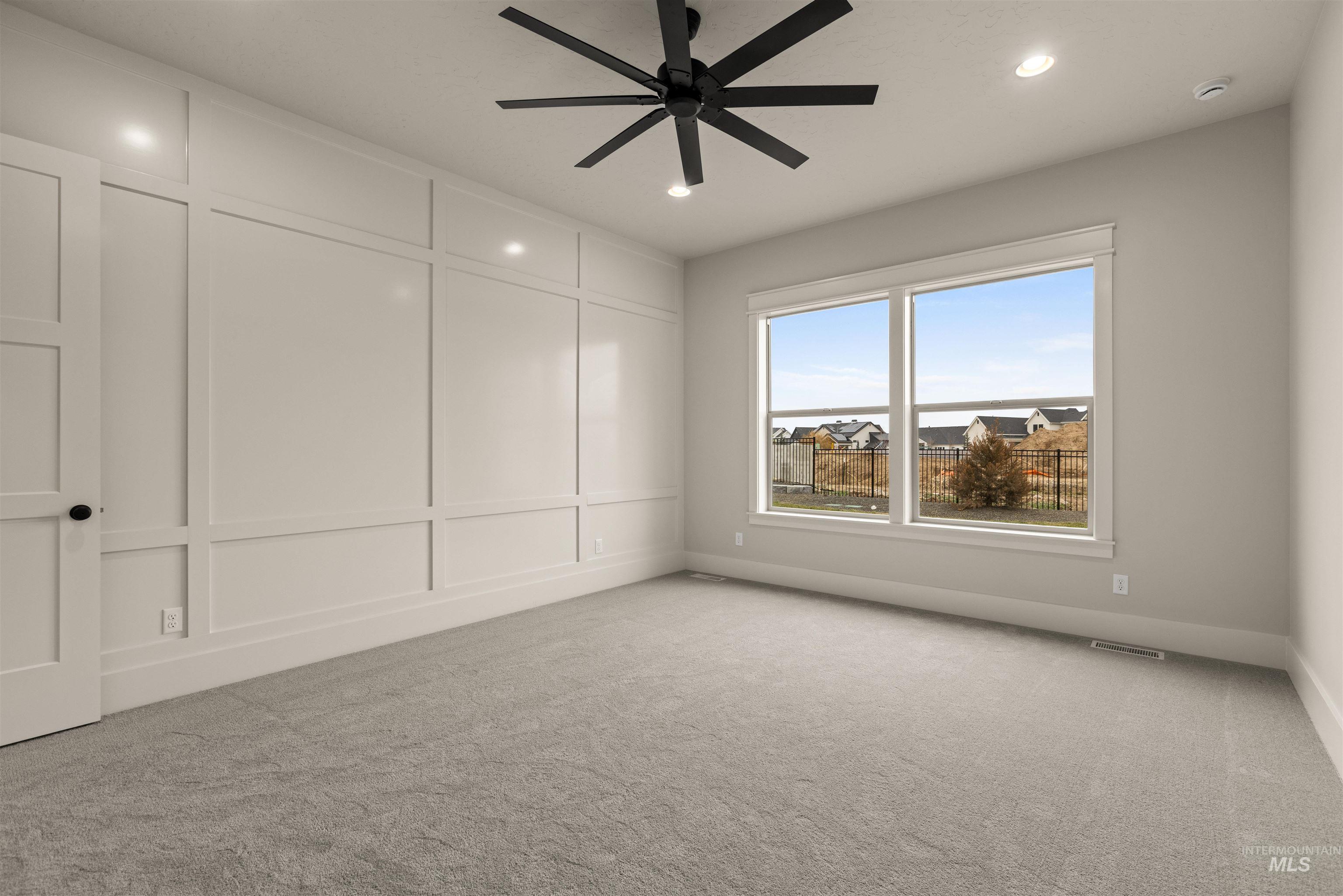 6844 South Messner Way Meridian, ID 83642 - Photo 23 of 49 Empty room featuring carpet floors, a ceiling fan, a decorative wall, and recessed lighting