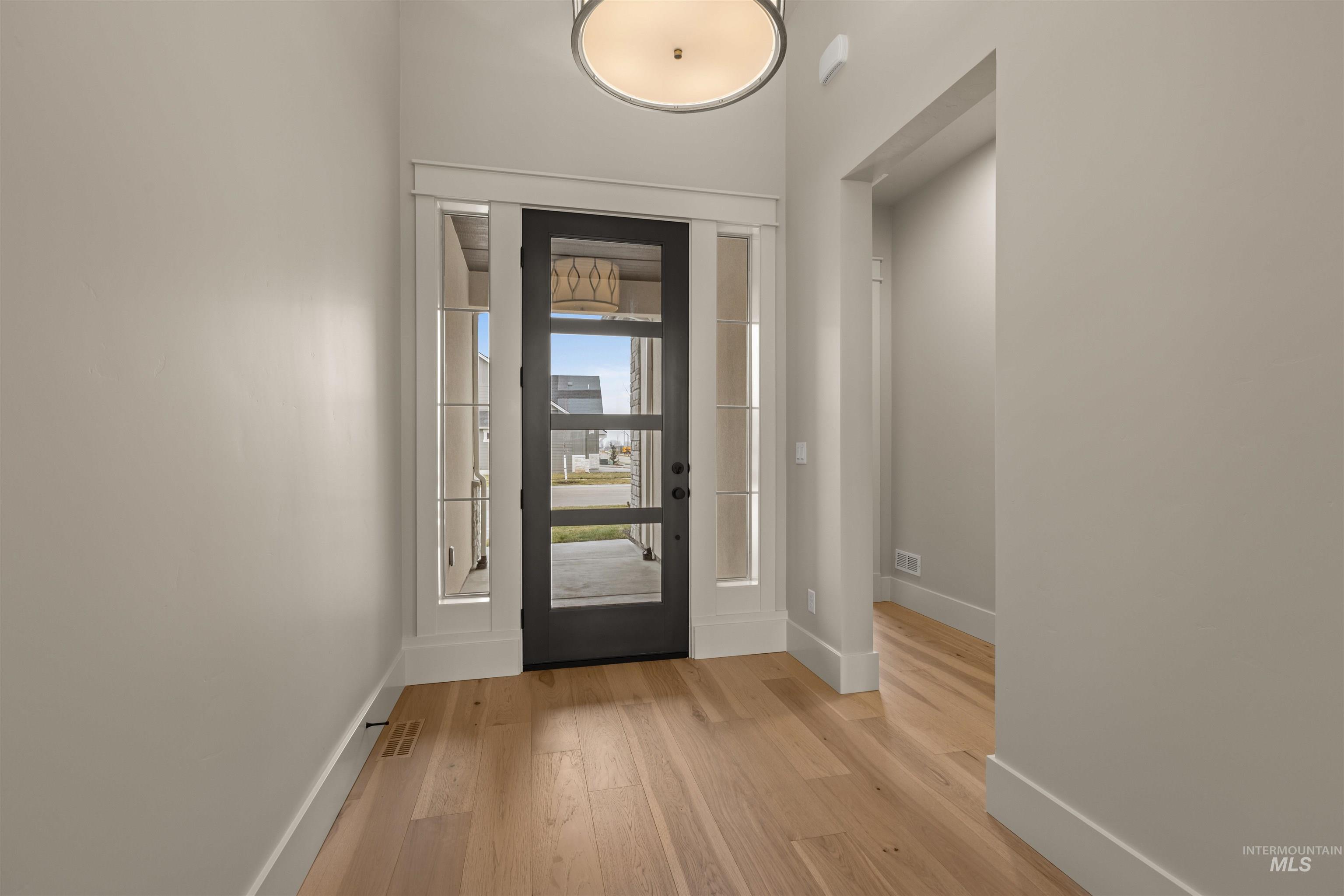 6844 South Messner Way Meridian, ID 83642 - Photo 3 of 49 Entryway featuring light wood-style floors and baseboards