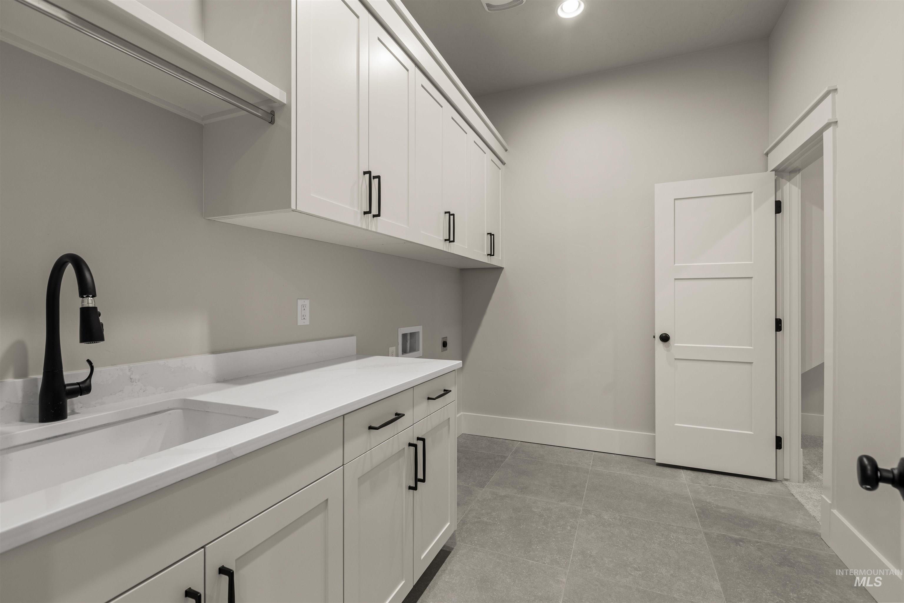 6844 South Messner Way Meridian, ID 83642 - Photo 32 of 49 Washroom featuring cabinet space, washer hookup, electric dryer hookup, recessed lighting, and light tile patterned floors