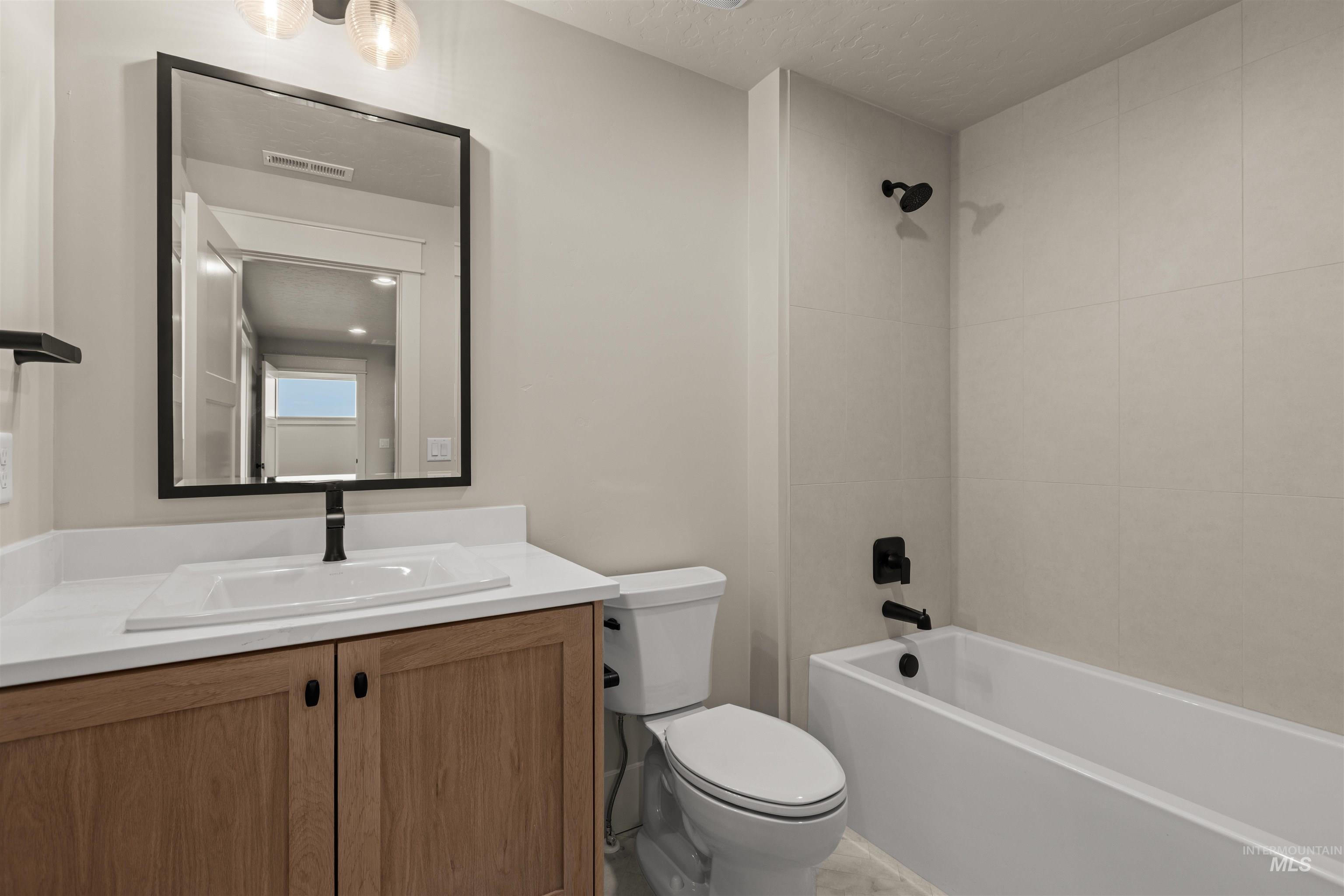 6844 South Messner Way Meridian, ID 83642 - Photo 37 of 49 Bathroom with vanity, shower combination, and a textured ceiling