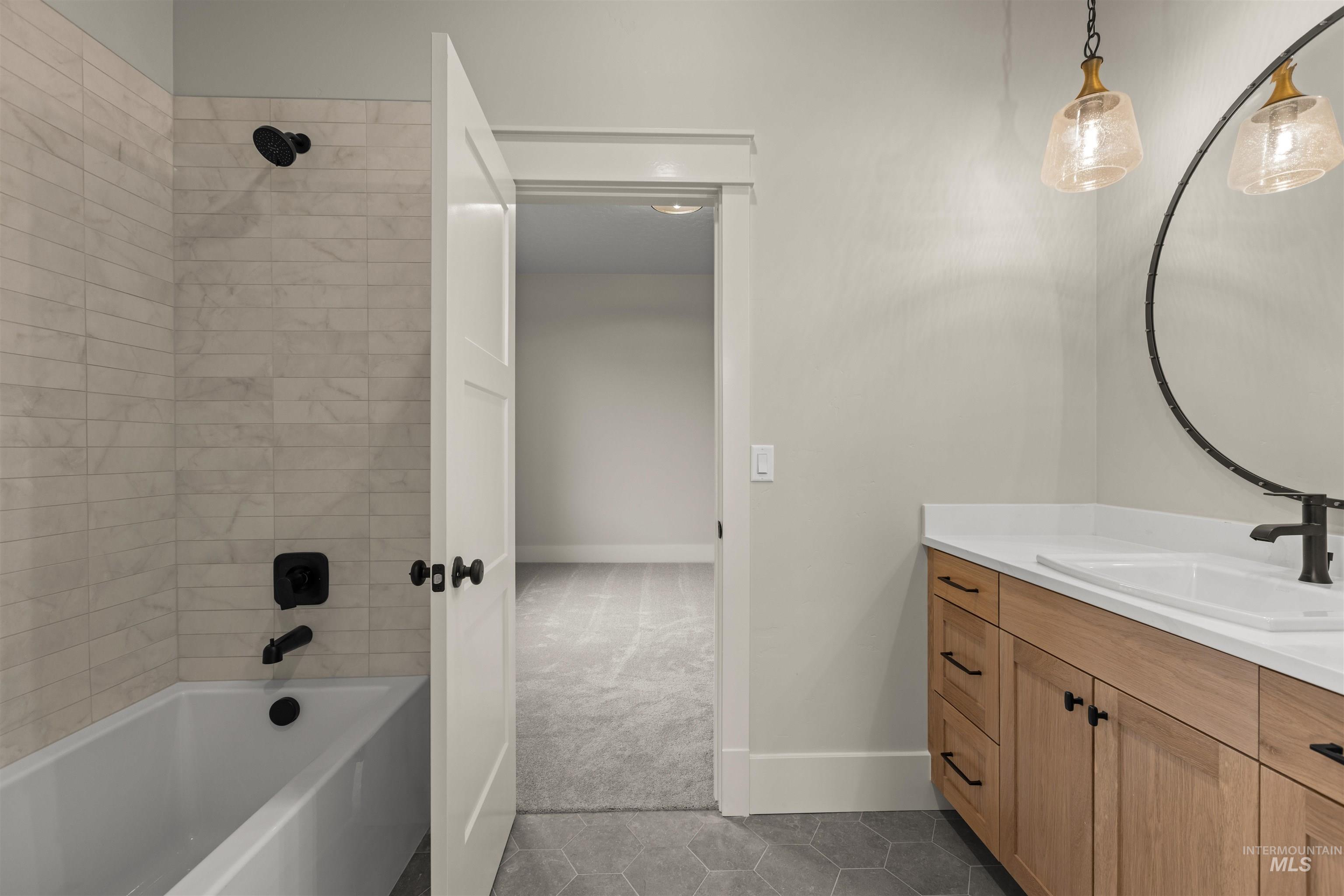 6844 South Messner Way Meridian, ID 83642 - Photo 7 of 49 Full bath featuring light tile patterned floors, vanity, shower combination, and light carpet