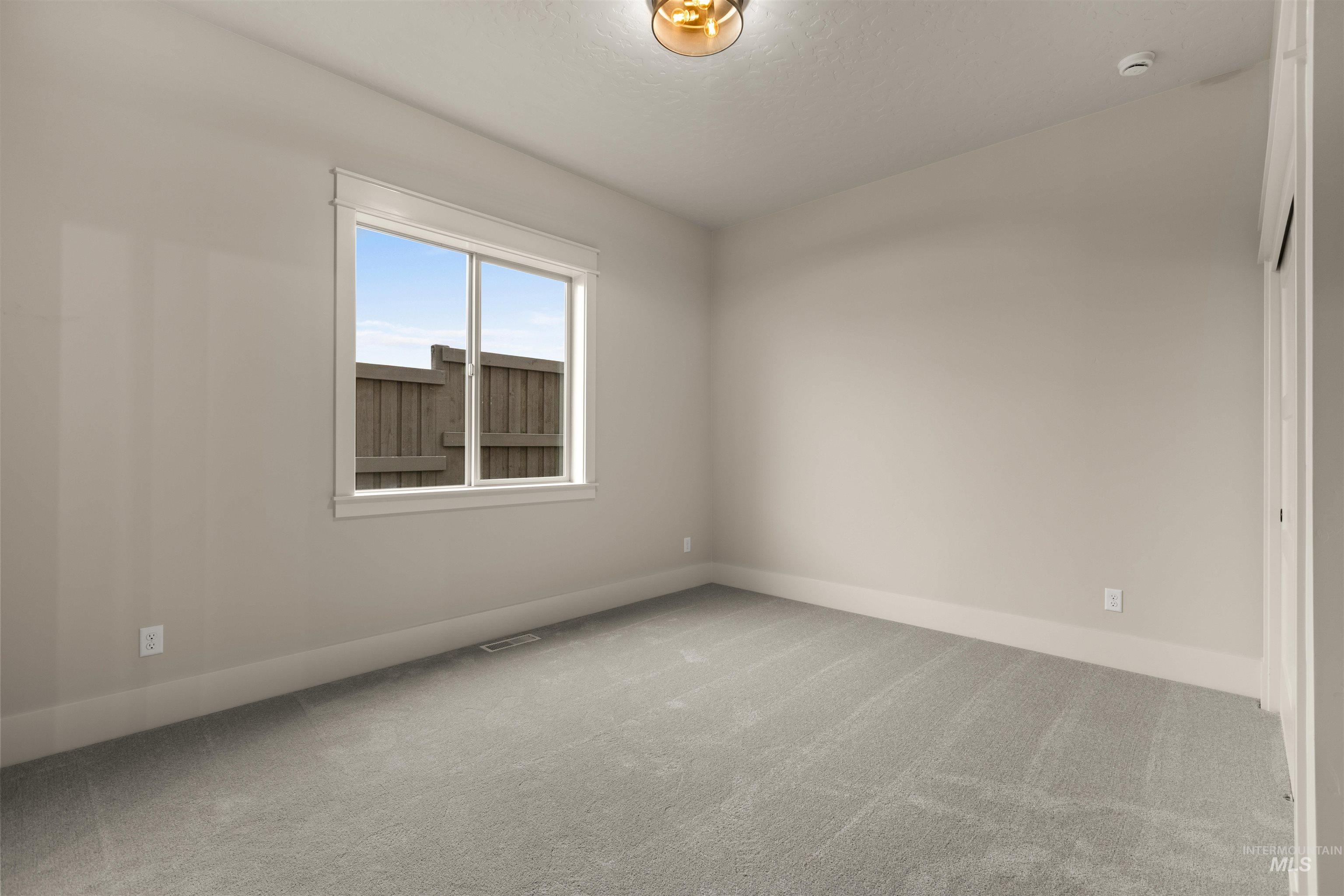 6844 South Messner Way Meridian, ID 83642 - Photo 9 of 49 Empty room with light colored carpet