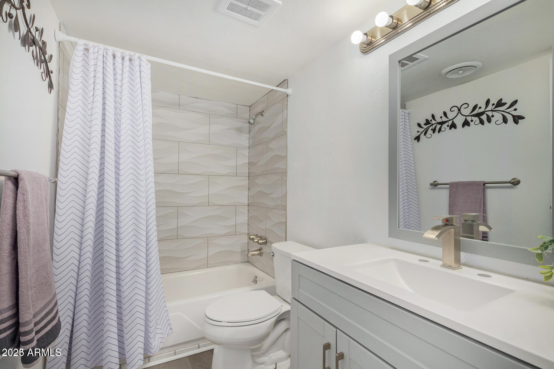 7625 East Camelback Road, Unit A133 Scottsdale, AZ 85251 - Photo 15 of 26 a bathroom with a granite countertop sink a toilet a mirror a vanity and shower