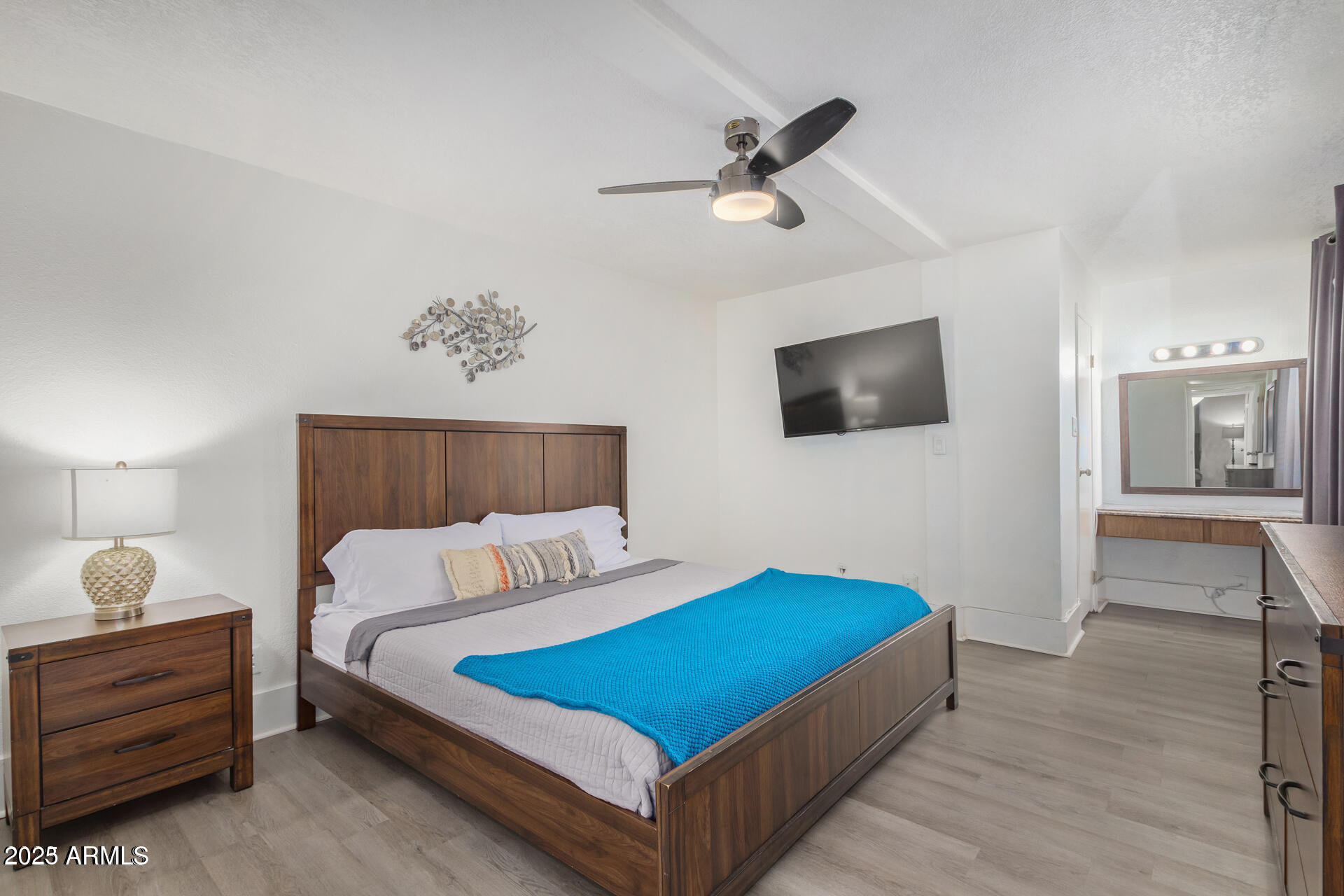 7625 East Camelback Road, Unit A133 Scottsdale, AZ 85251 - Photo 16 of 26 a bedroom with a bed and a chandelier