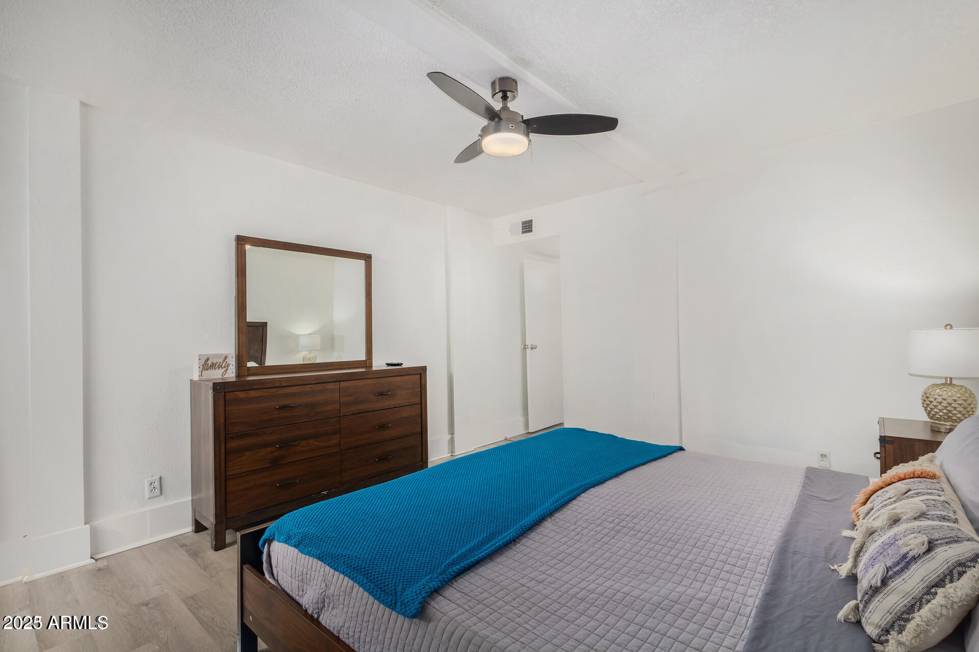 7625 East Camelback Road, Unit A133 Scottsdale, AZ 85251 - Photo 17 of 26 a bedroom with a bed and a dresser
