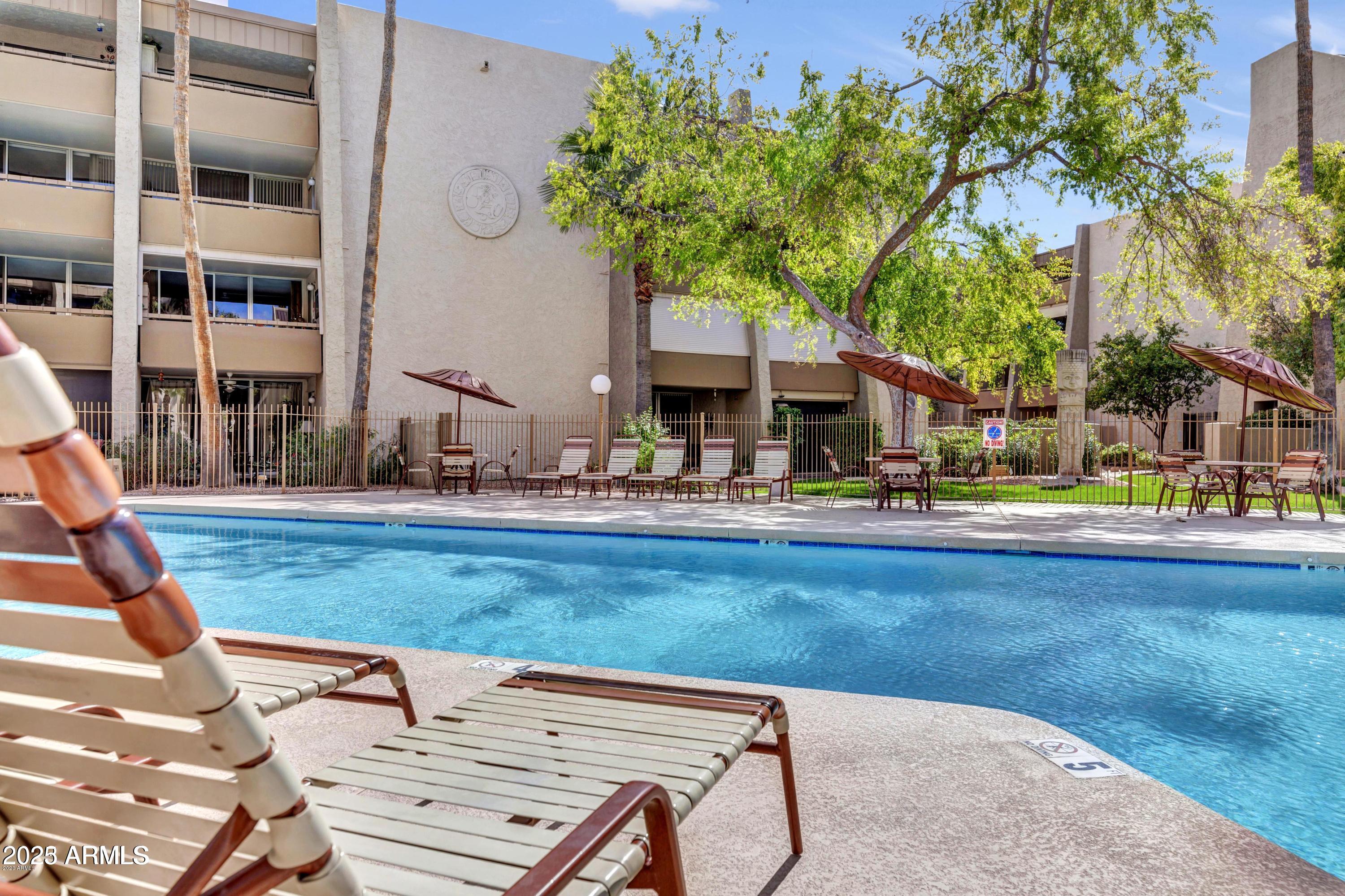 7625 East Camelback Road, Unit A133 Scottsdale, AZ 85251 - Photo 2 of 26 a backyard of a house with barbeque oven table and chairs