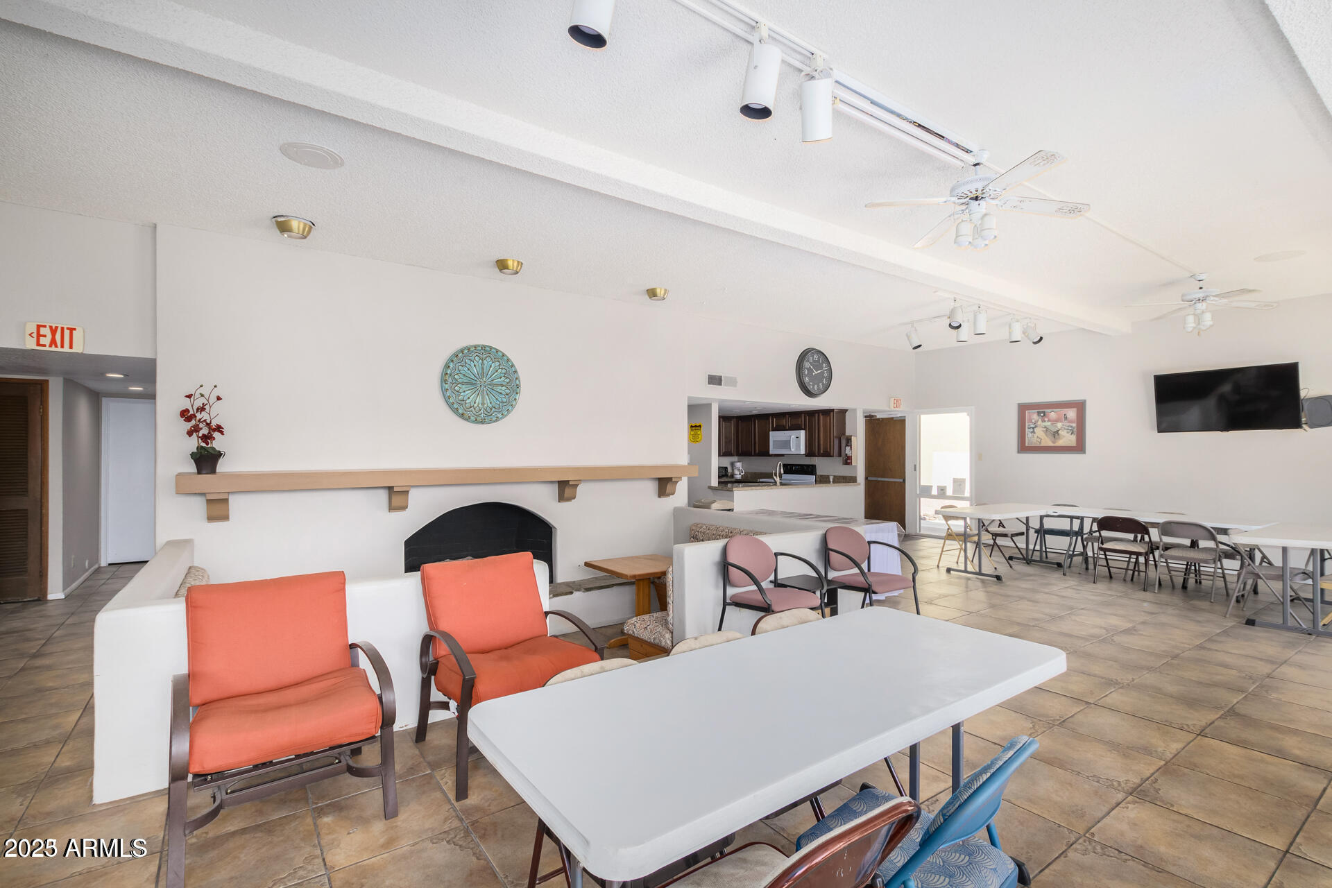 7625 East Camelback Road, Unit A133 Scottsdale, AZ 85251 - Photo 23 of 26 a living room with furniture a rug and a chandelier