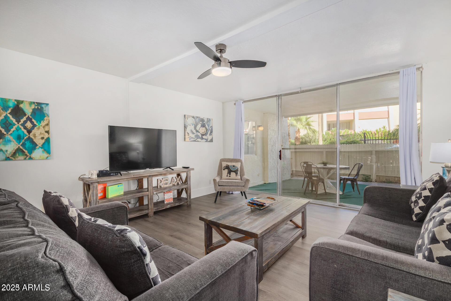 7625 East Camelback Road, Unit A133 Scottsdale, AZ 85251 - Photo 26 of 26 a living room with furniture and a flat screen tv