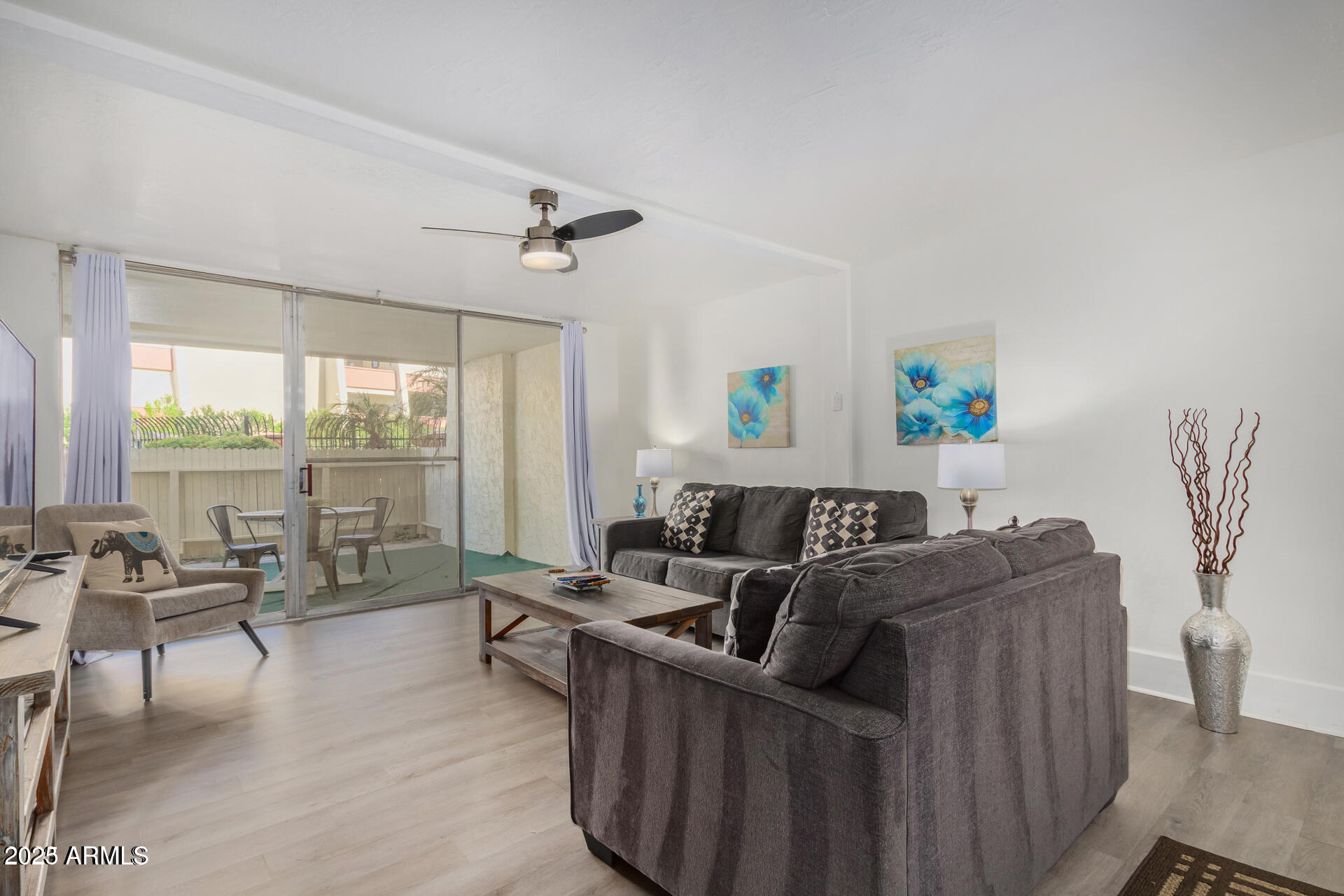 7625 East Camelback Road, Unit A133 Scottsdale, AZ 85251 - Photo 7 of 26 a living room with furniture and a large window