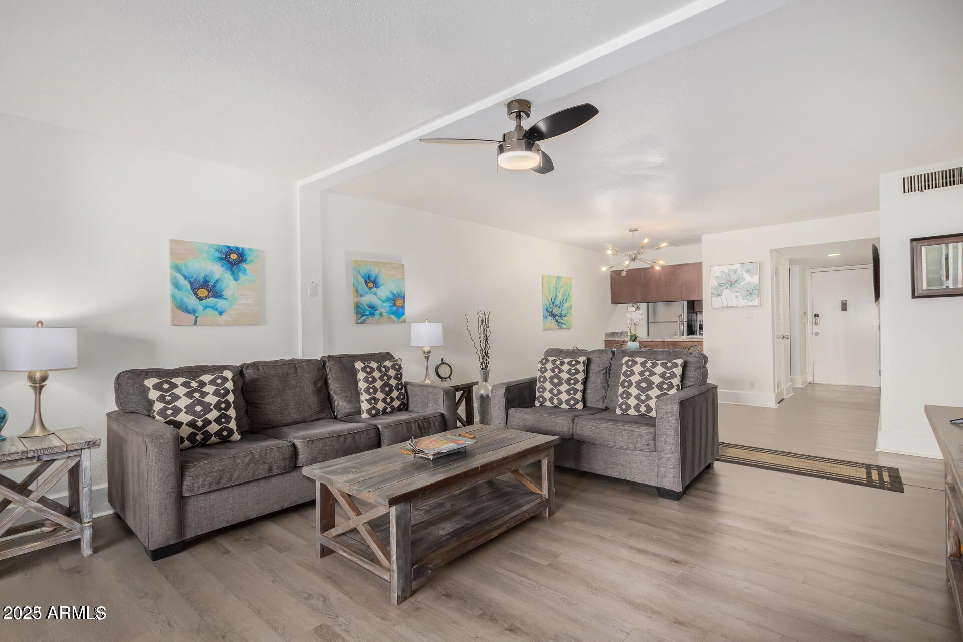7625 East Camelback Road, Unit A133 Scottsdale, AZ 85251 - Photo 8 of 26 a living room with furniture and a wooden floor