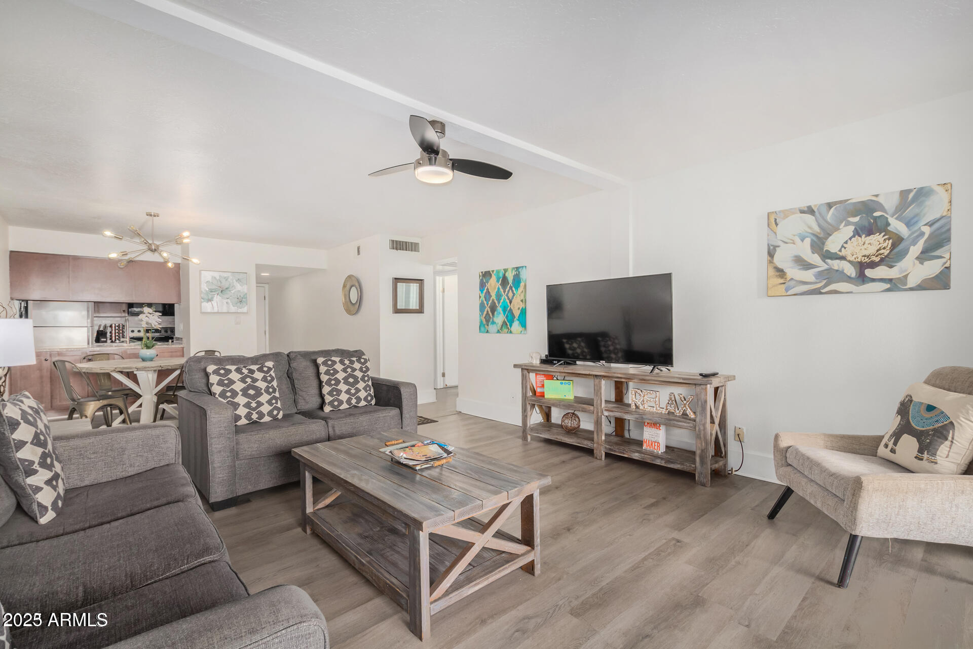7625 East Camelback Road, Unit A133 Scottsdale, AZ 85251 - Photo 9 of 26 a living room with furniture and a flat screen tv