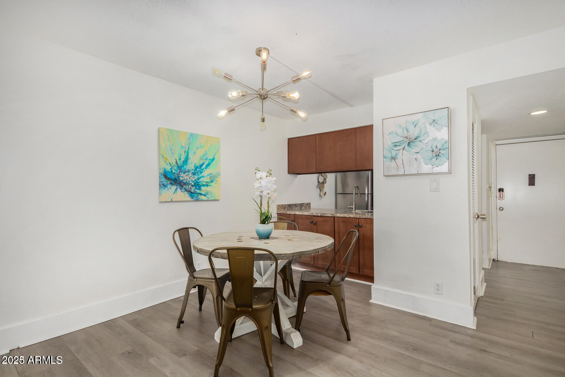 7625 East Camelback Road, Unit A133 Scottsdale, AZ 85251 - Photo 10 of 26 a view of a dining room with furniture and wooden floor