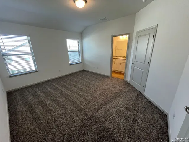 an empty room with windows and closet