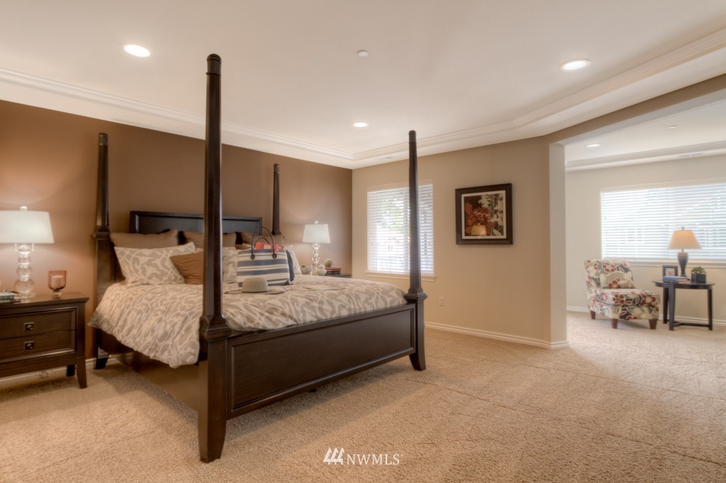18201 41st Avenue Southeast Bothell, WA 98012 - Photo 9 of 19 a bedroom with a bed a table and chair