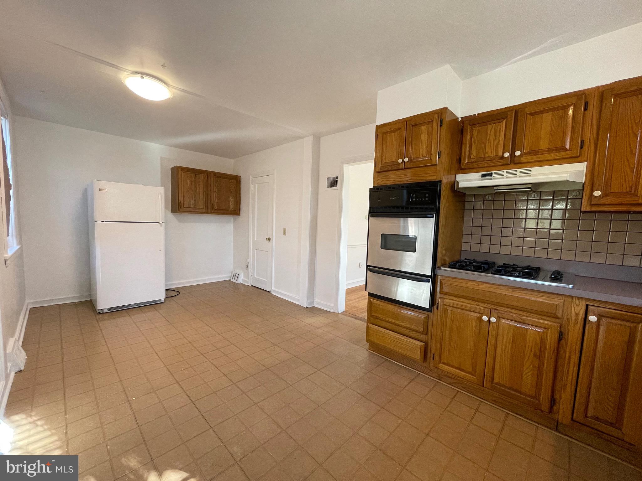 7940 Church Road Jenkintown, PA 19046 - Photo 13 of 38 a kitchen with stainless steel appliances a refrigerator and a stove top oven