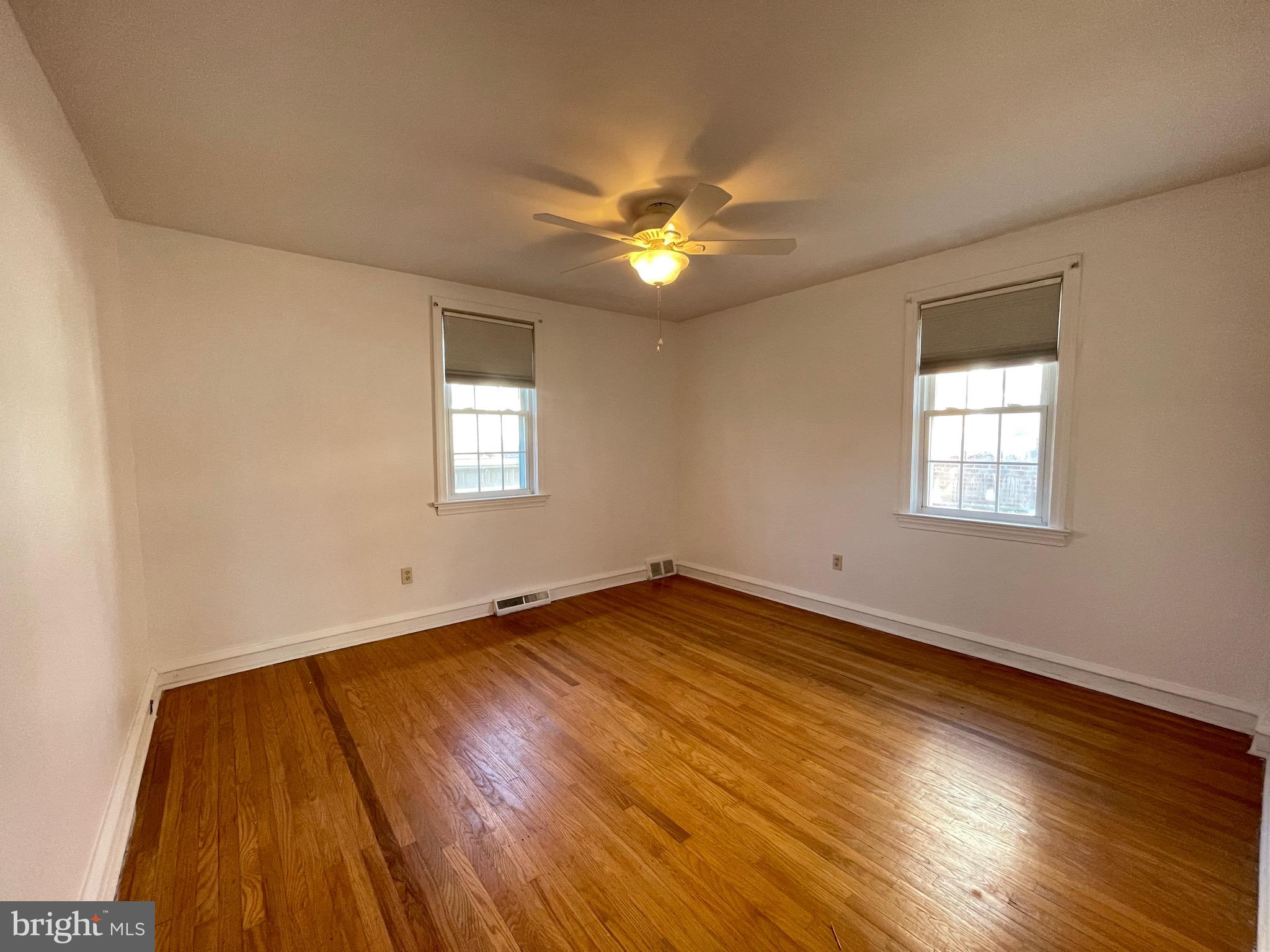 7940 Church Road Jenkintown, PA 19046 - Photo 21 of 38 a view of an empty room with wooden floor and a window