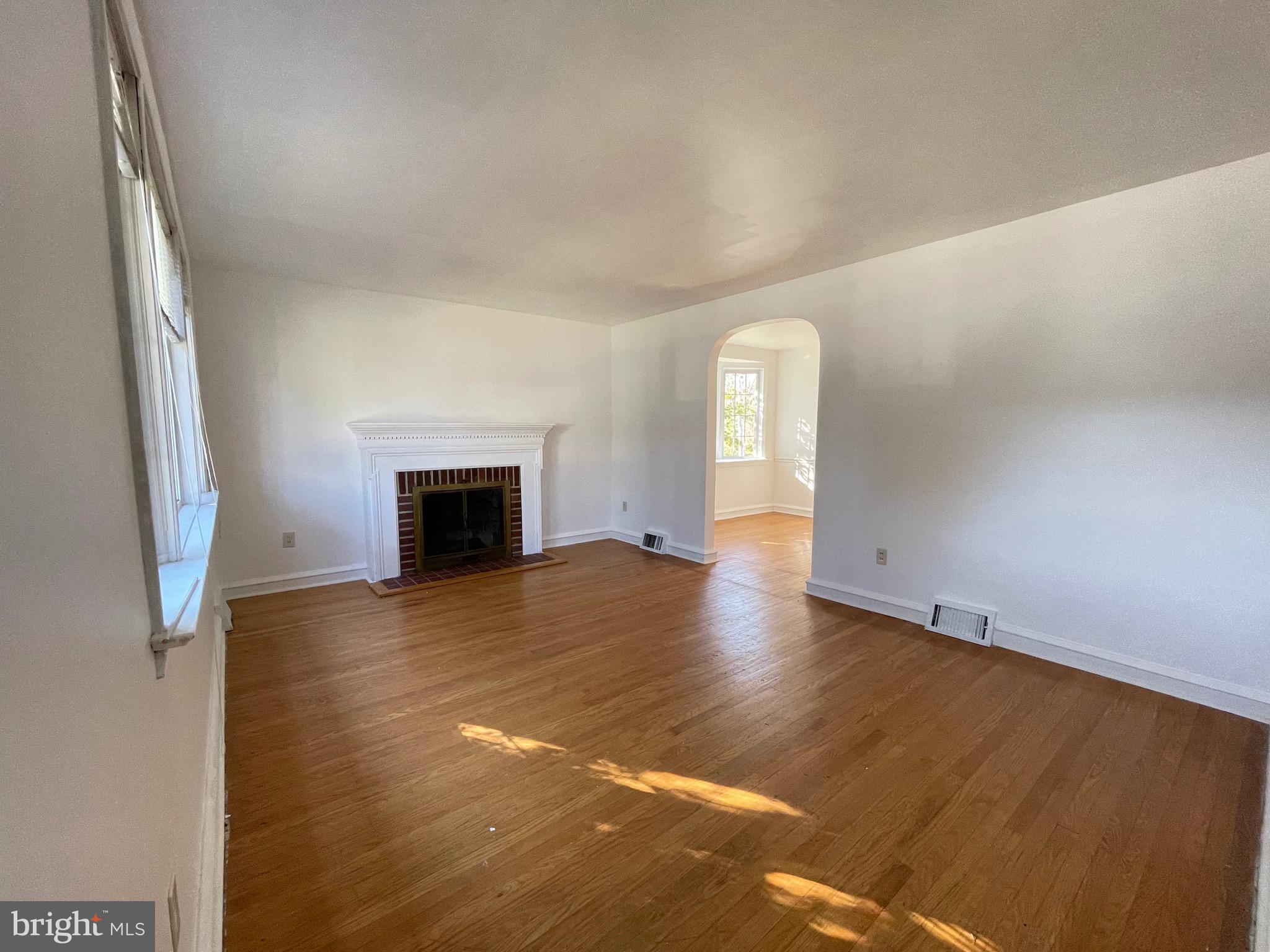 7940 Church Road Jenkintown, PA 19046 - Photo 4 of 38 a view of empty room with wooden floor and fireplace