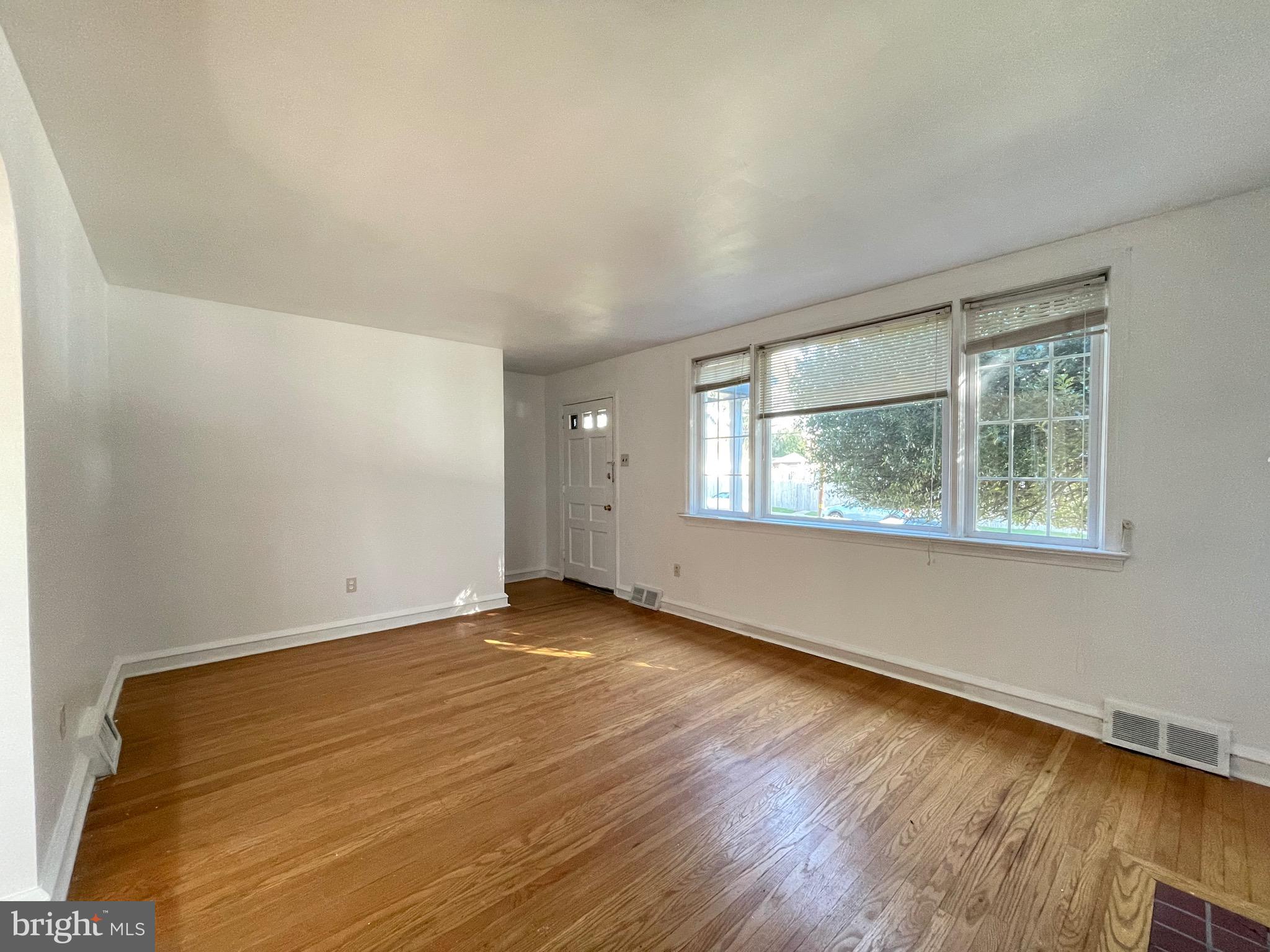 7940 Church Road Jenkintown, PA 19046 - Photo 6 of 38 an empty room with wooden floor and windows