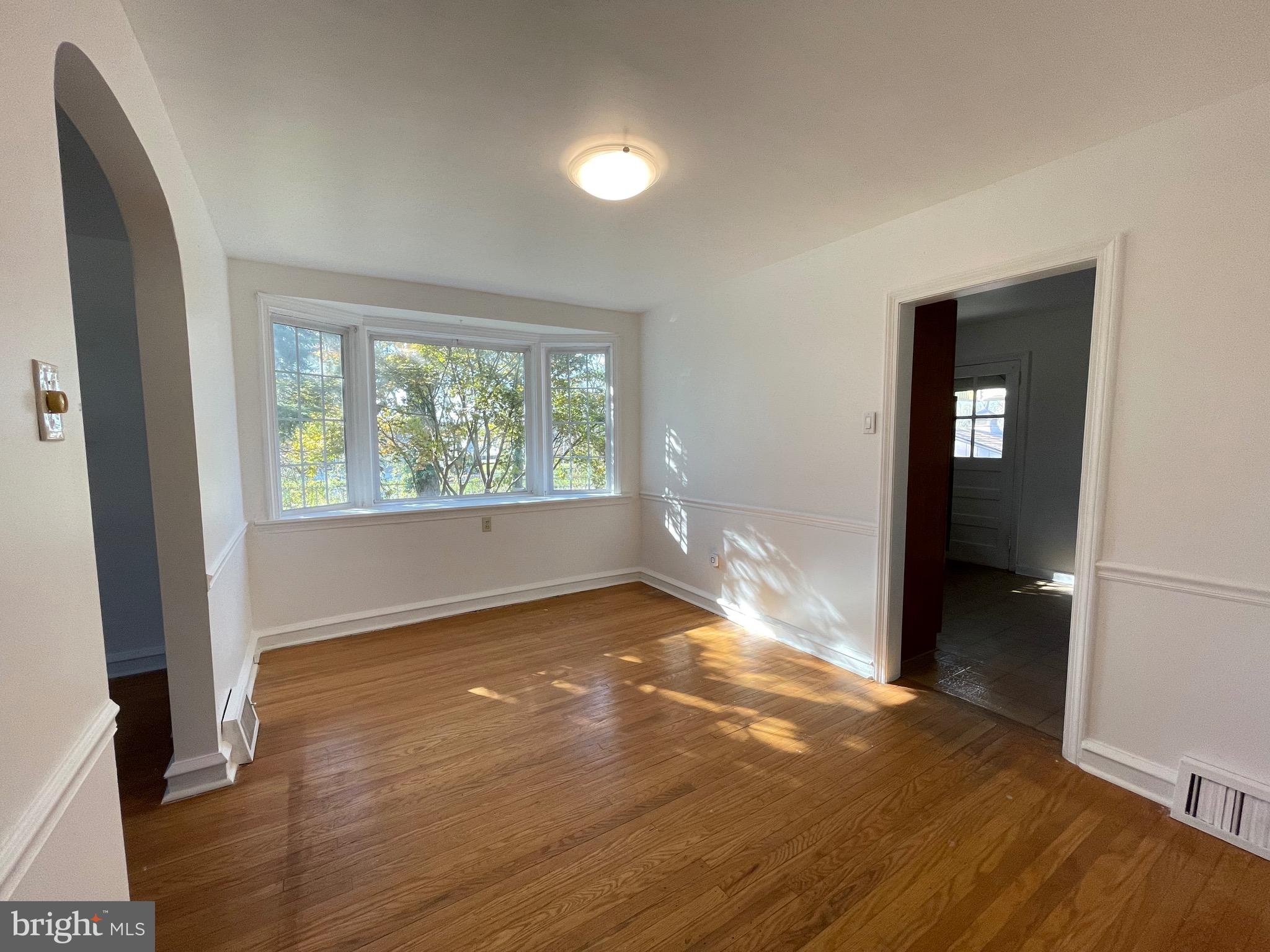 7940 Church Road Jenkintown, PA 19046 - Photo 9 of 38 an empty room with wooden floor and windows