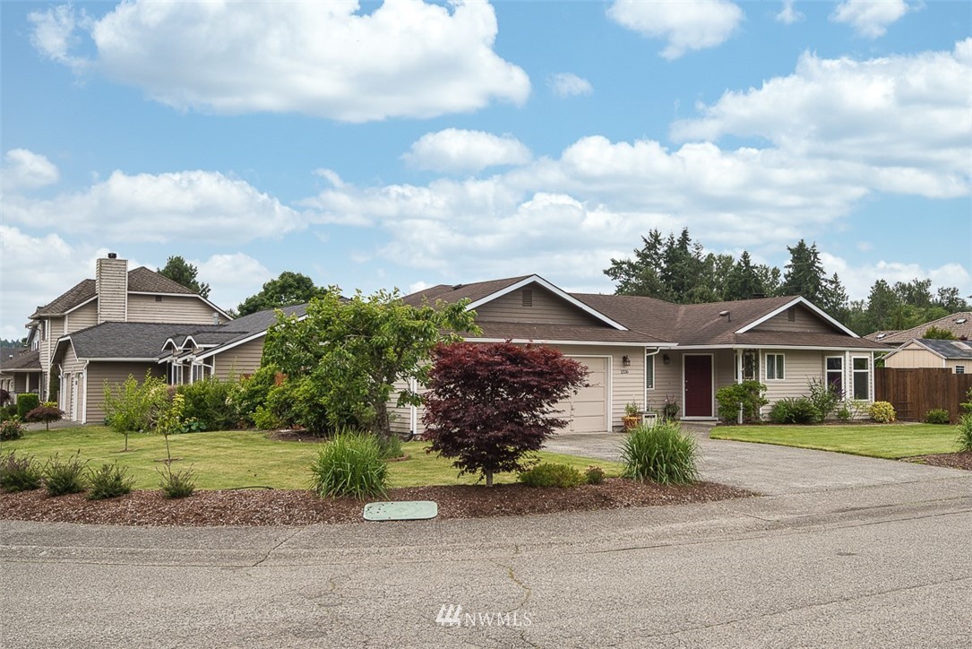 1326 232nd Place Southwest Bothell, WA 98021 - Photo 2 of 23 a front view of a house with a garden