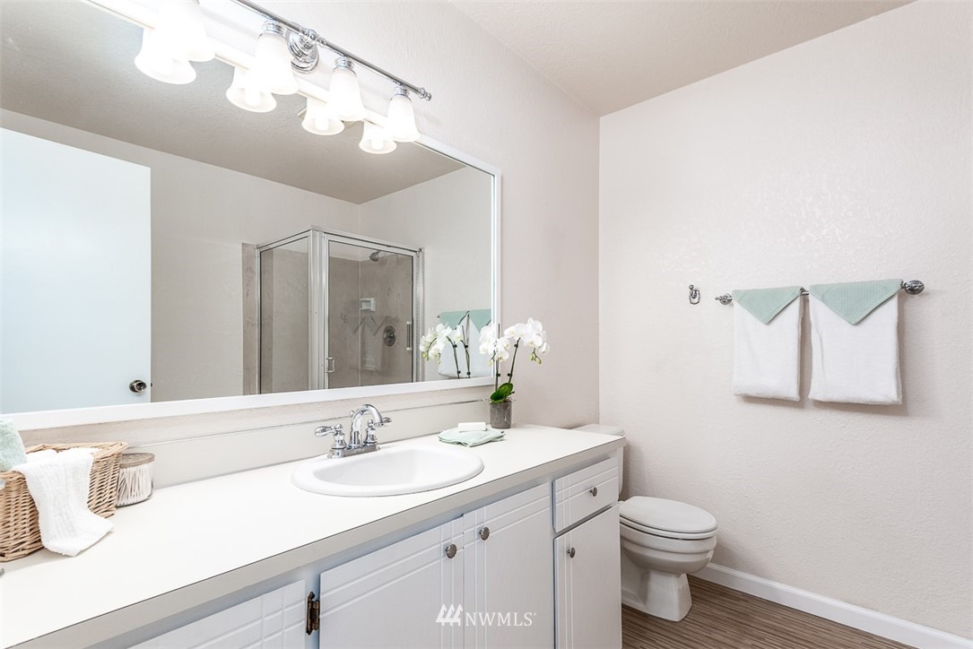 1326 232nd Place Southwest Bothell, WA 98021 - Photo 15 of 23 a bathroom with a granite countertop sink mirror vanity and toilet