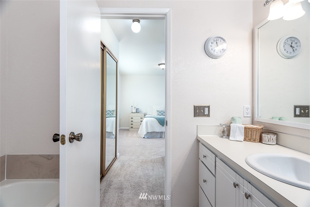 1326 232nd Place Southwest Bothell, WA 98021 - Photo 16 of 23 a spacious bathroom with a tub sink and mirror