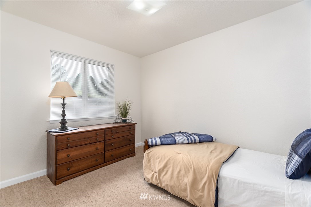 1326 232nd Place Southwest Bothell, WA 98021 - Photo 17 of 23 a bedroom with a bed and a lamp on dresser
