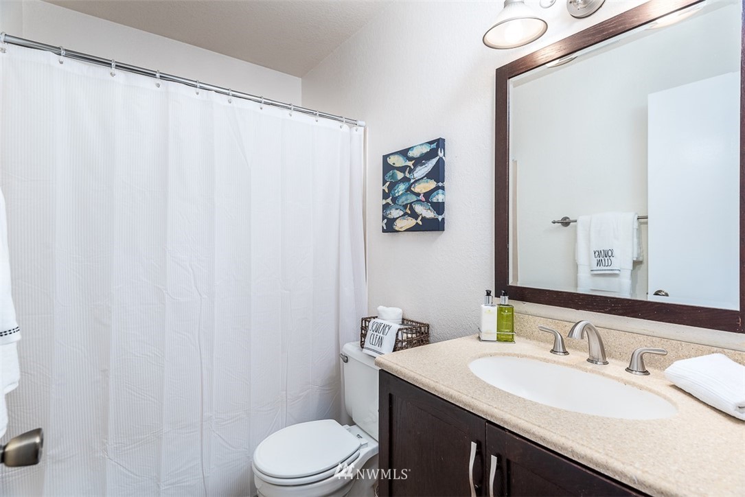 1326 232nd Place Southwest Bothell, WA 98021 - Photo 18 of 23 a bathroom with a sink vanity mirror and toilet