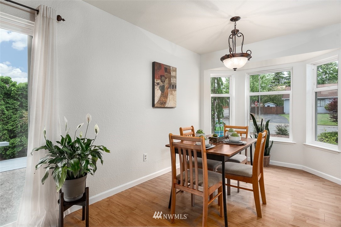 1326 232nd Place Southwest Bothell, WA 98021 - Photo 7 of 23 a view of a dining room with furniture window and wooden floor