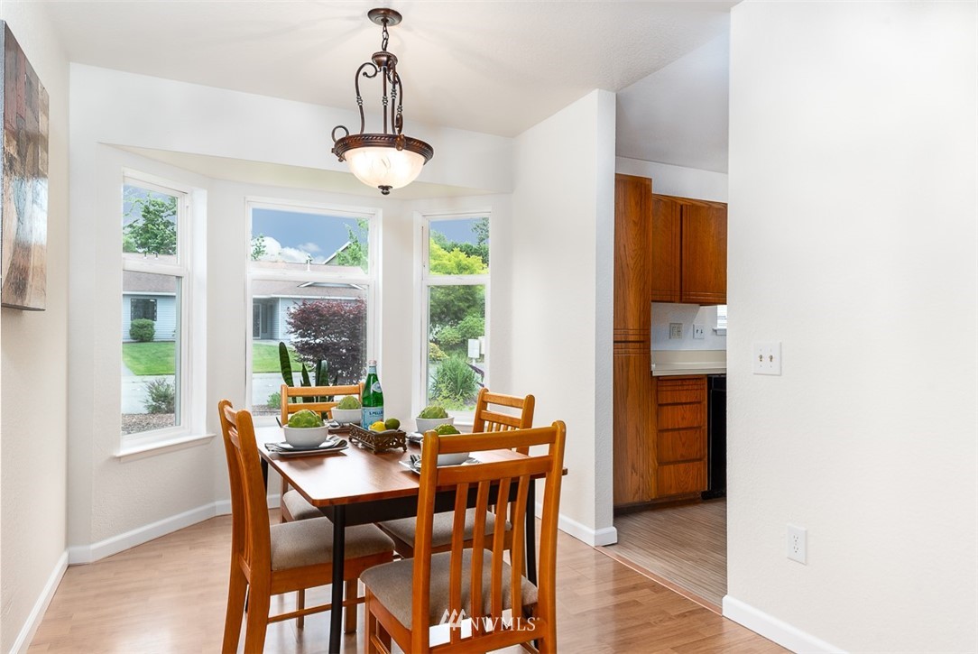1326 232nd Place Southwest Bothell, WA 98021 - Photo 8 of 23 a view of a dining room with furniture window and wooden floor