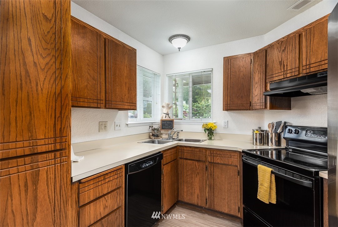 1326 232nd Place Southwest Bothell, WA 98021 - Photo 9 of 23 a kitchen with a sink a stove and cabinets