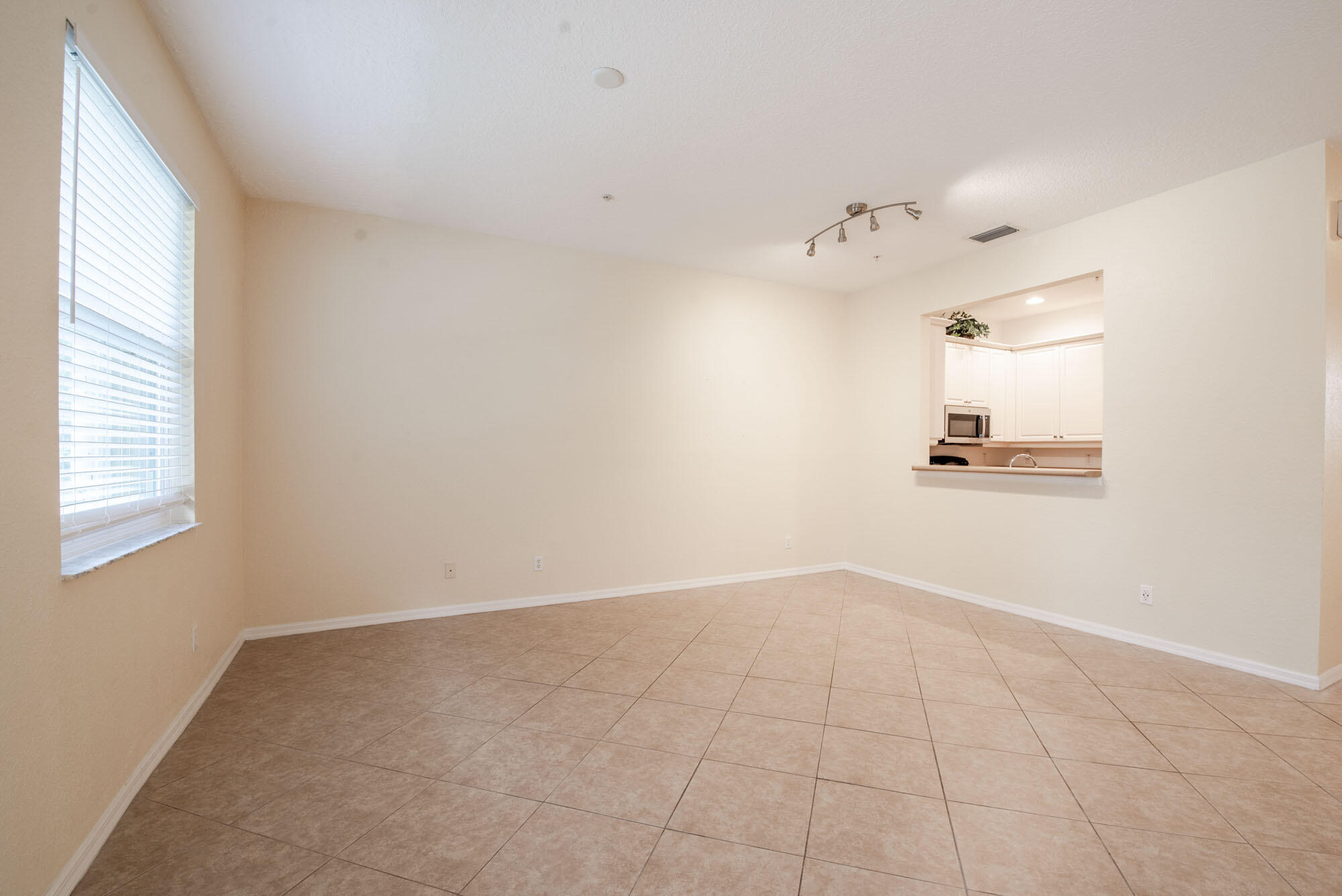 1484 Frederick Small Road Jupiter, FL 33458 - Photo 5 of 19 an empty room with windows and cabinet