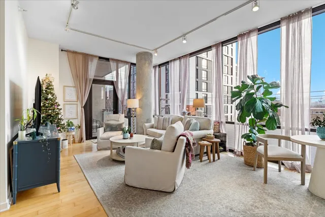 a living room with furniture a large window and a table