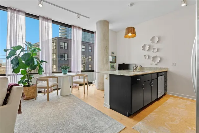 a kitchen with a sink and living room