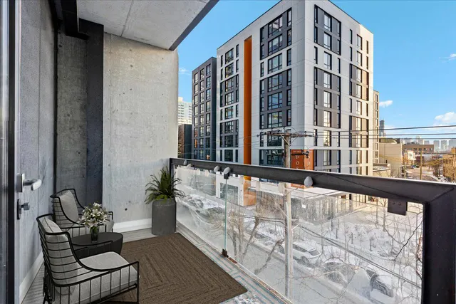 a view of balcony with outdoor seating and city view