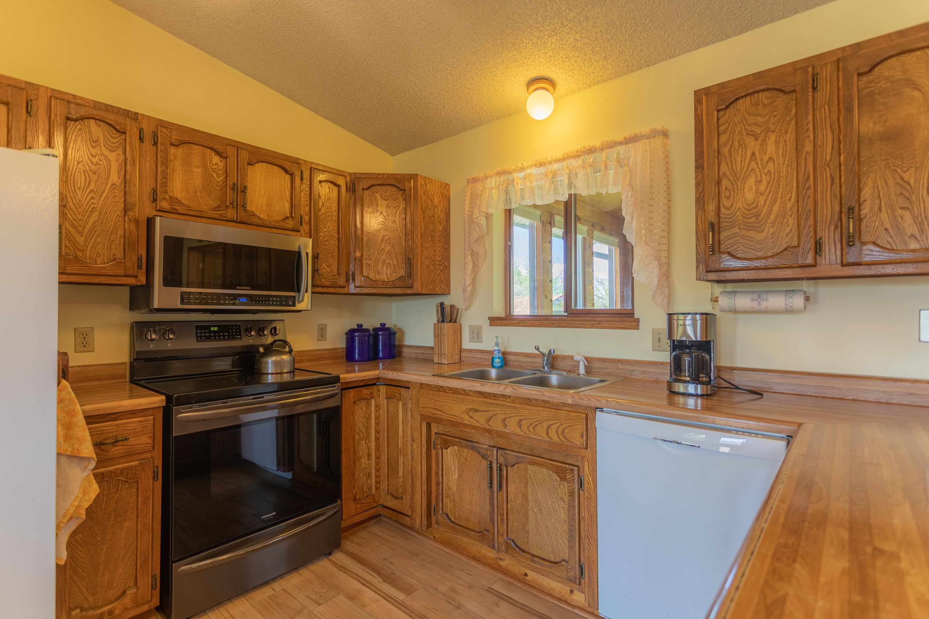 477 35 Road Palisade, CO 81526 - Photo 11 of 32 a kitchen with stainless steel appliances granite countertop a sink stove and microwave