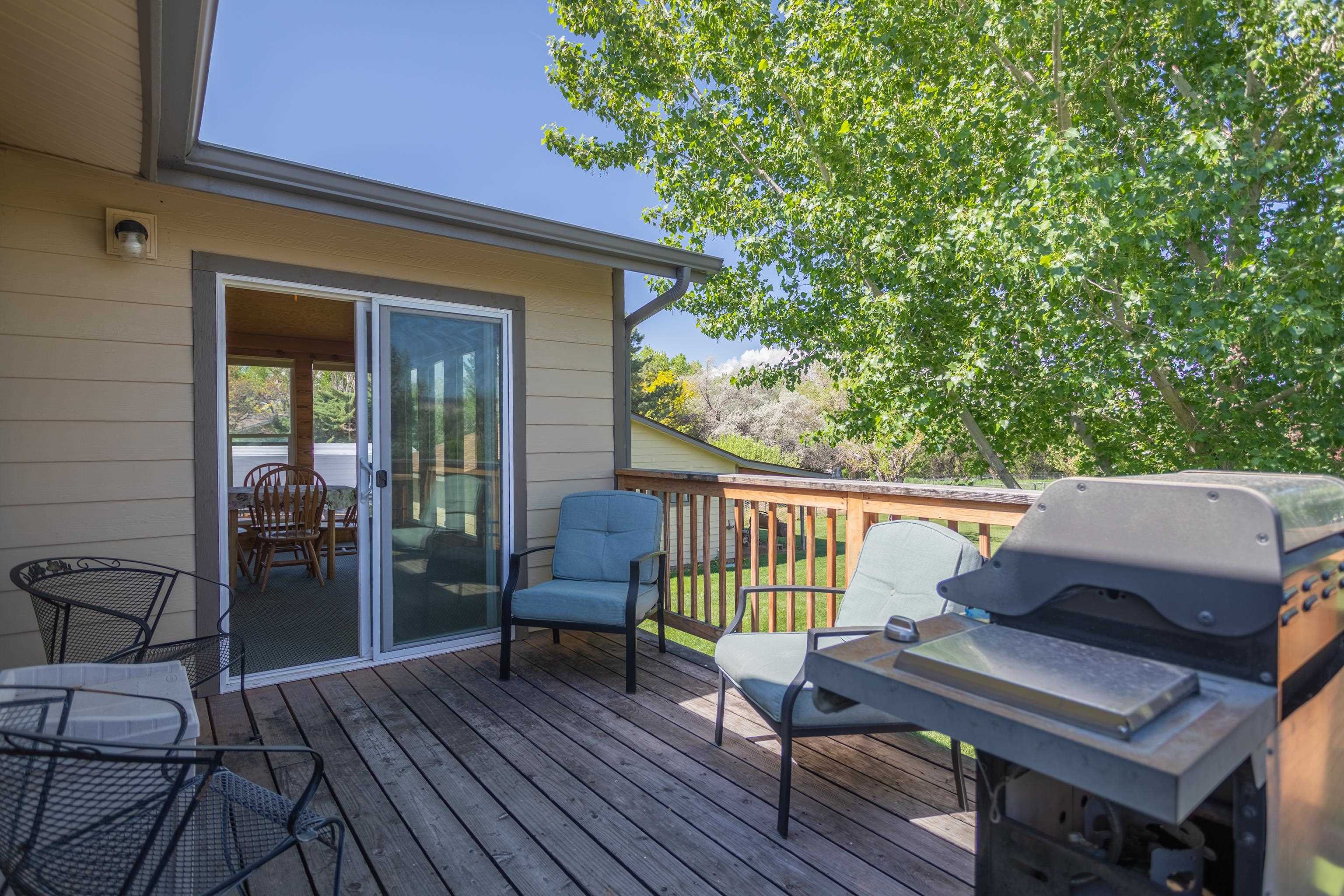 477 35 Road Palisade, CO 81526 - Photo 13 of 32 a view of balcony with wooden floor and outdoor seating