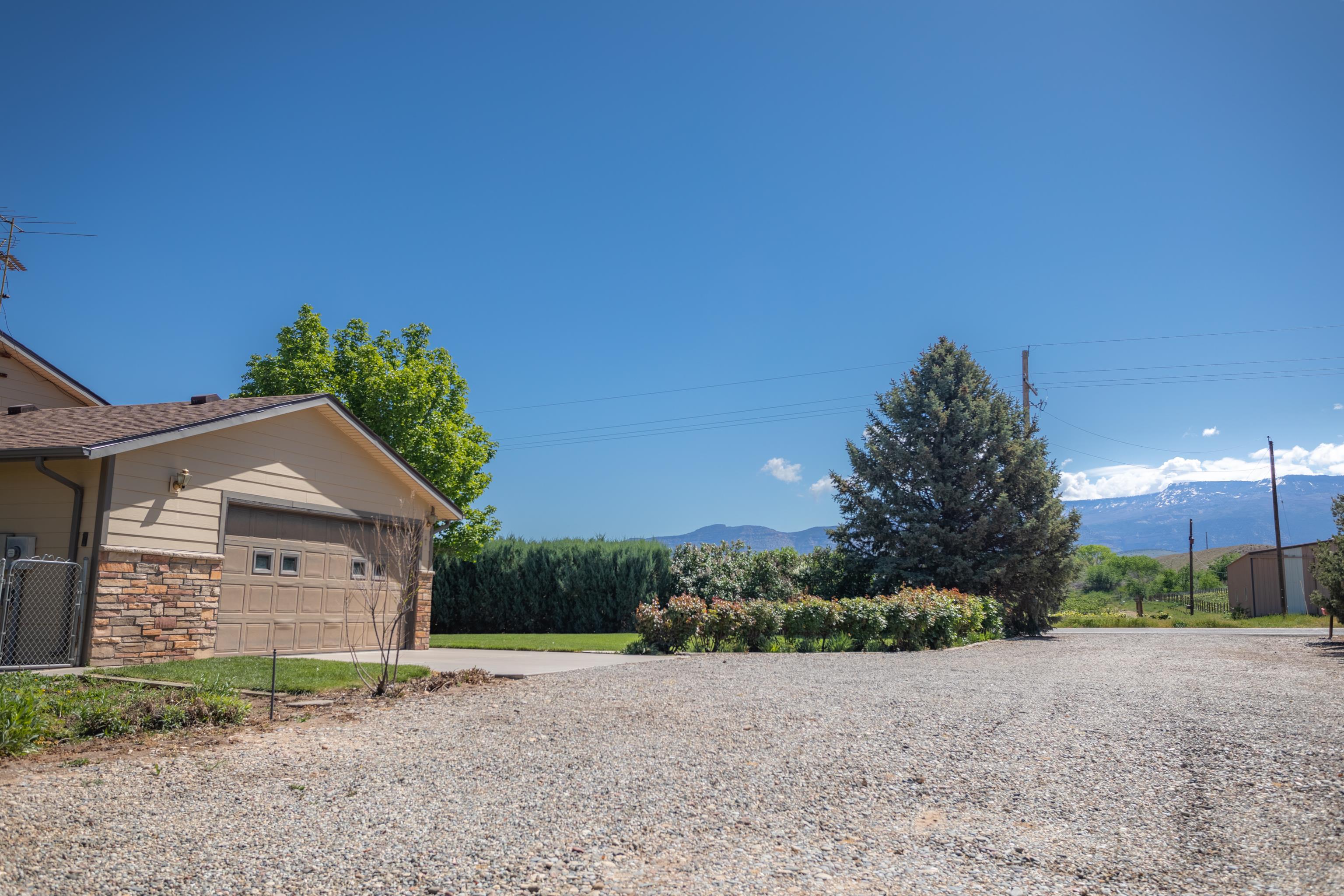 477 35 Road Palisade, CO 81526 - Photo 4 of 32 a view of a house with a yard and garage