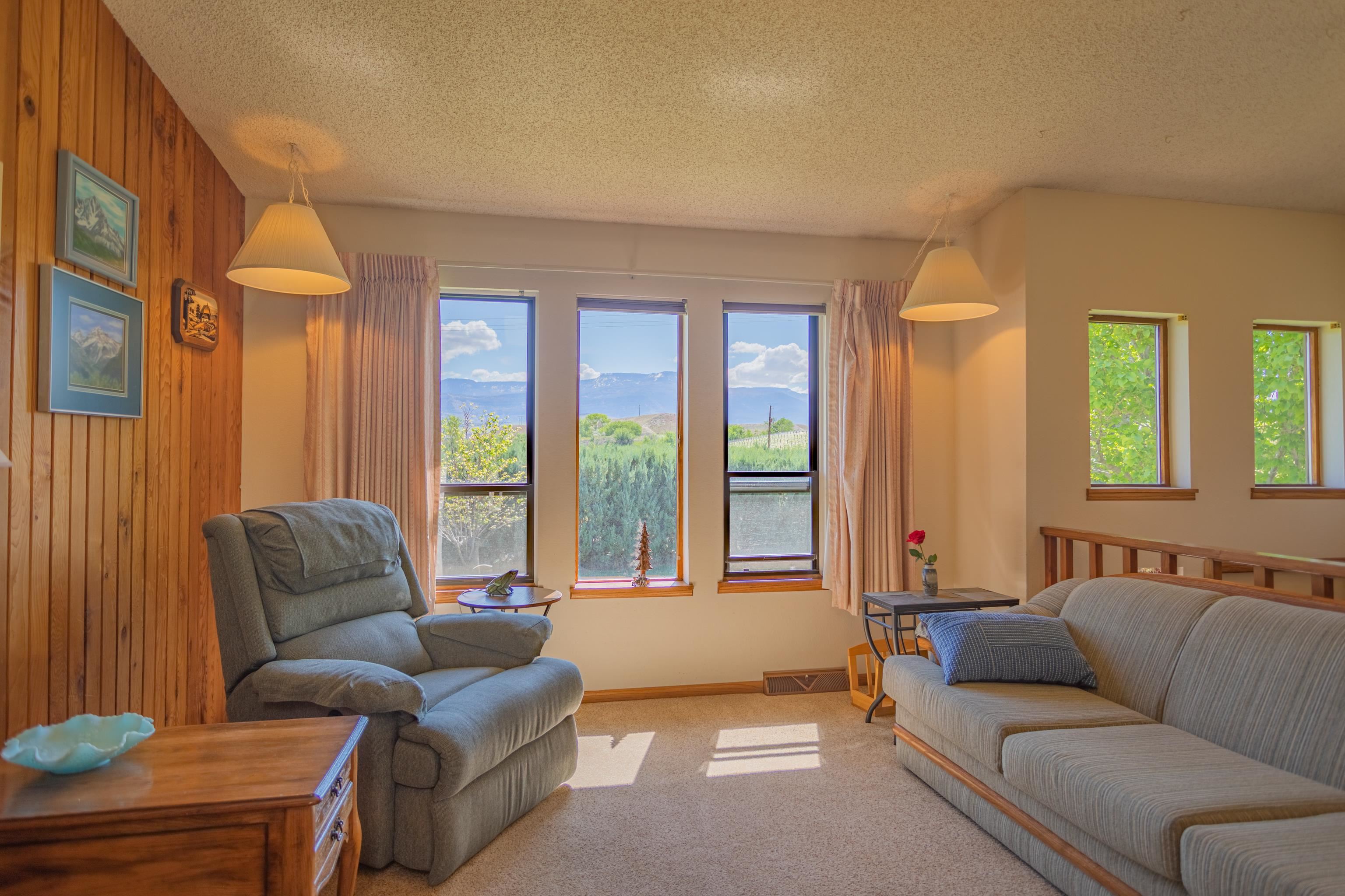 477 35 Road Palisade, CO 81526 - Photo 8 of 32 a living room with furniture and a large window