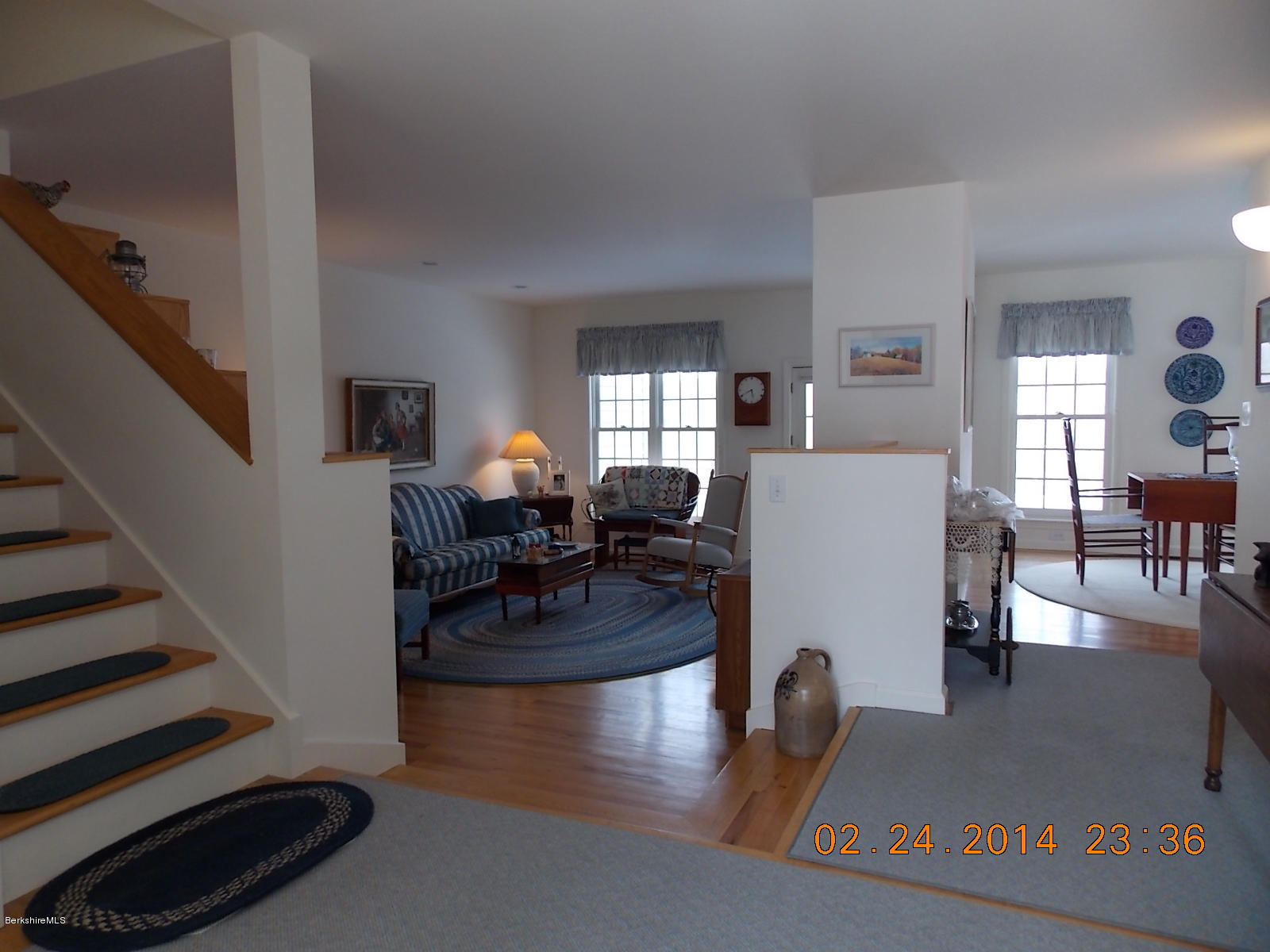 1136-9 Barker Road, Unit 9 Pittsfield, MA 01201 - Photo 4 of 45 a living room with furniture and a dining table with kitchen view