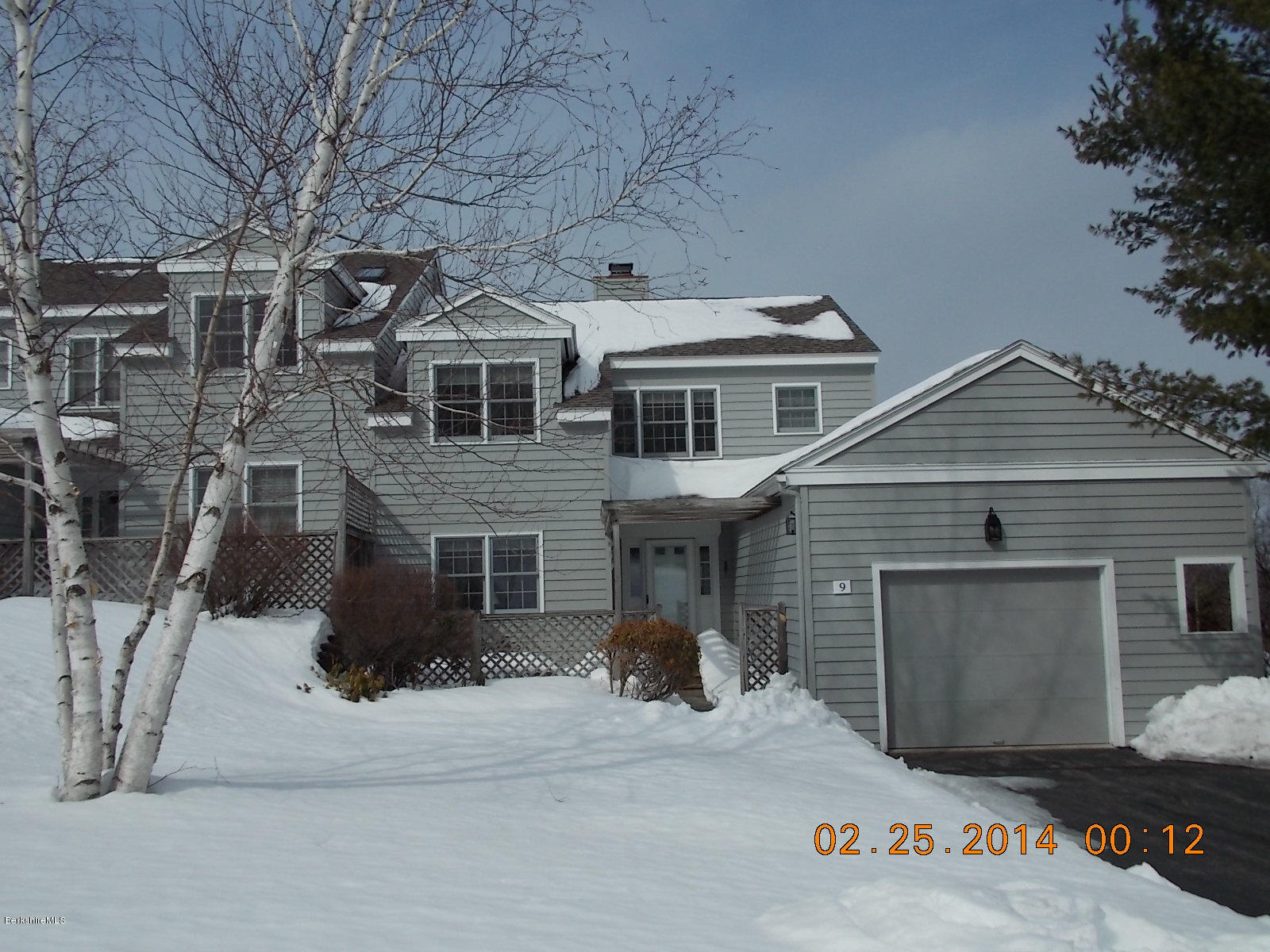 1136-9 Barker Road, Unit 9 Pittsfield, MA 01201 - Photo 39 of 45 a front view of a house with a garage