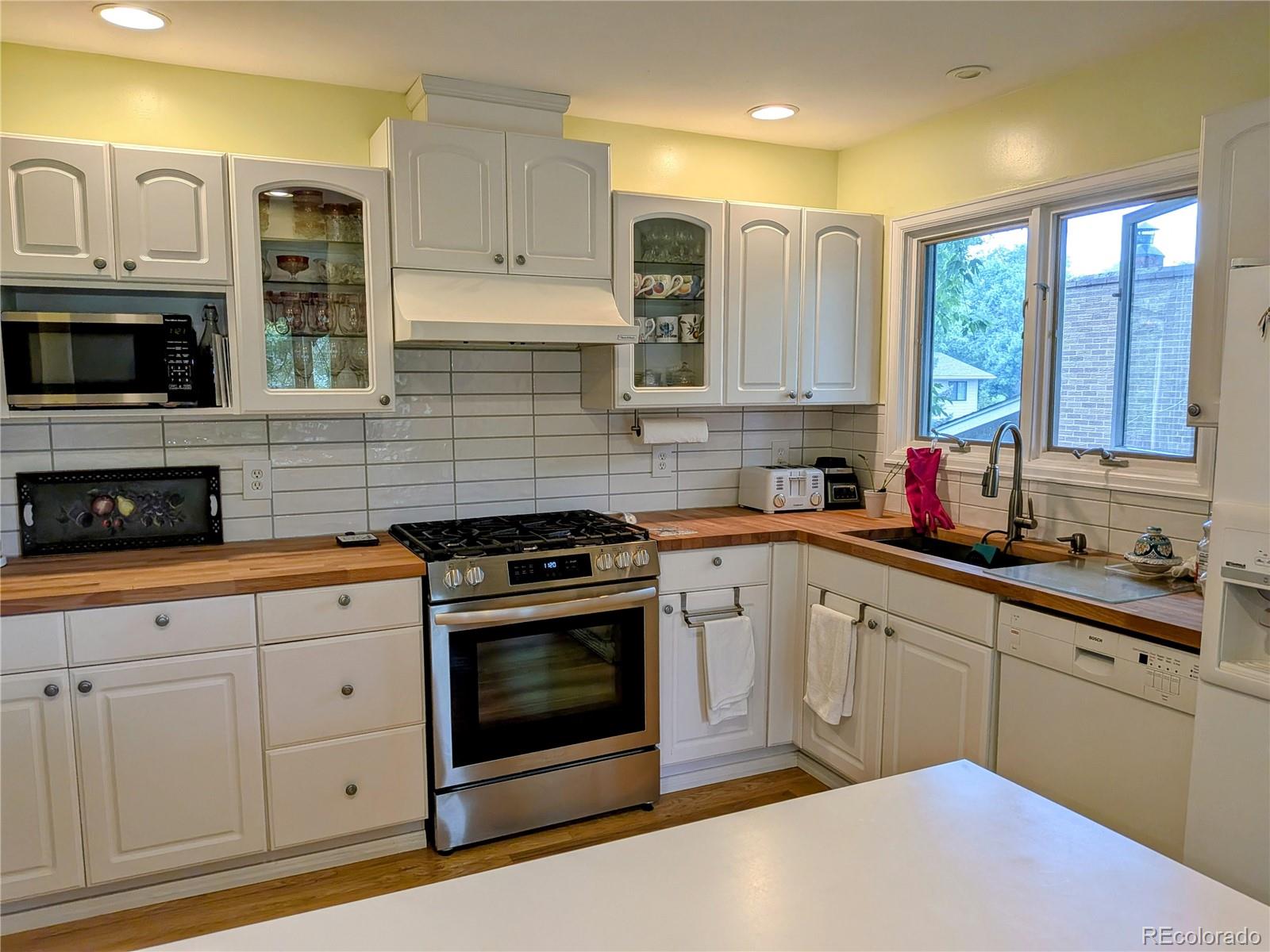 1080 Ithaca Drive Boulder, CO 80305 - Photo 20 of 35 a kitchen with stainless steel appliances granite countertop a stove sink and cabinets