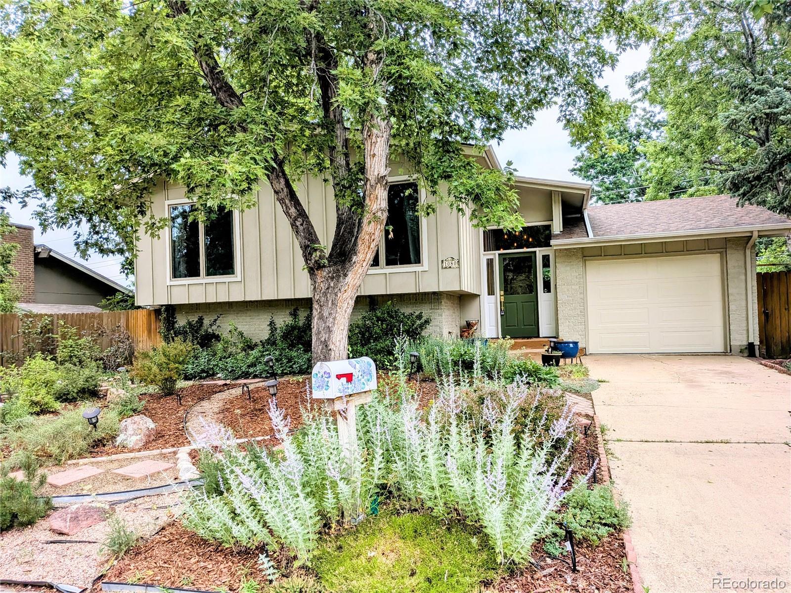 1080 Ithaca Drive Boulder, CO 80305 - Photo 2 of 35 a front view of a house with a yard and potted plants