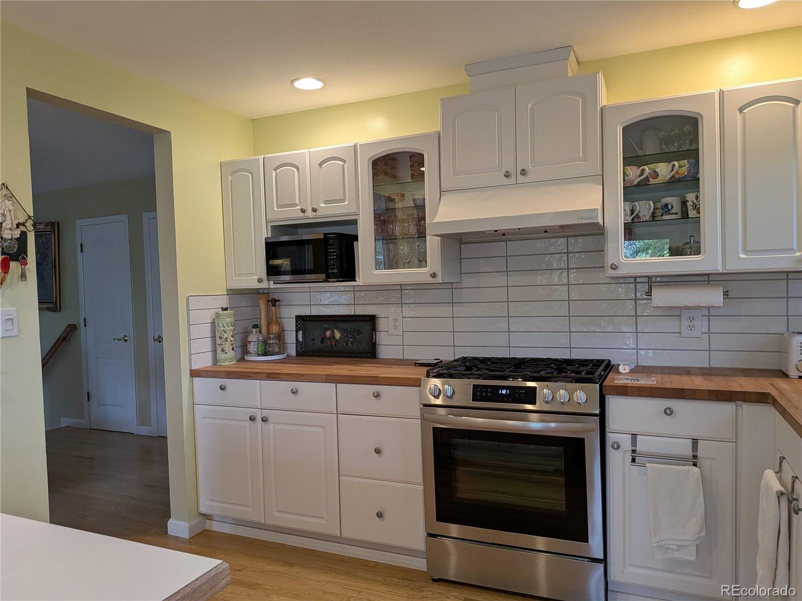 1080 Ithaca Drive Boulder, CO 80305 - Photo 21 of 35 a kitchen with cabinets stainless steel appliances and wooden floor