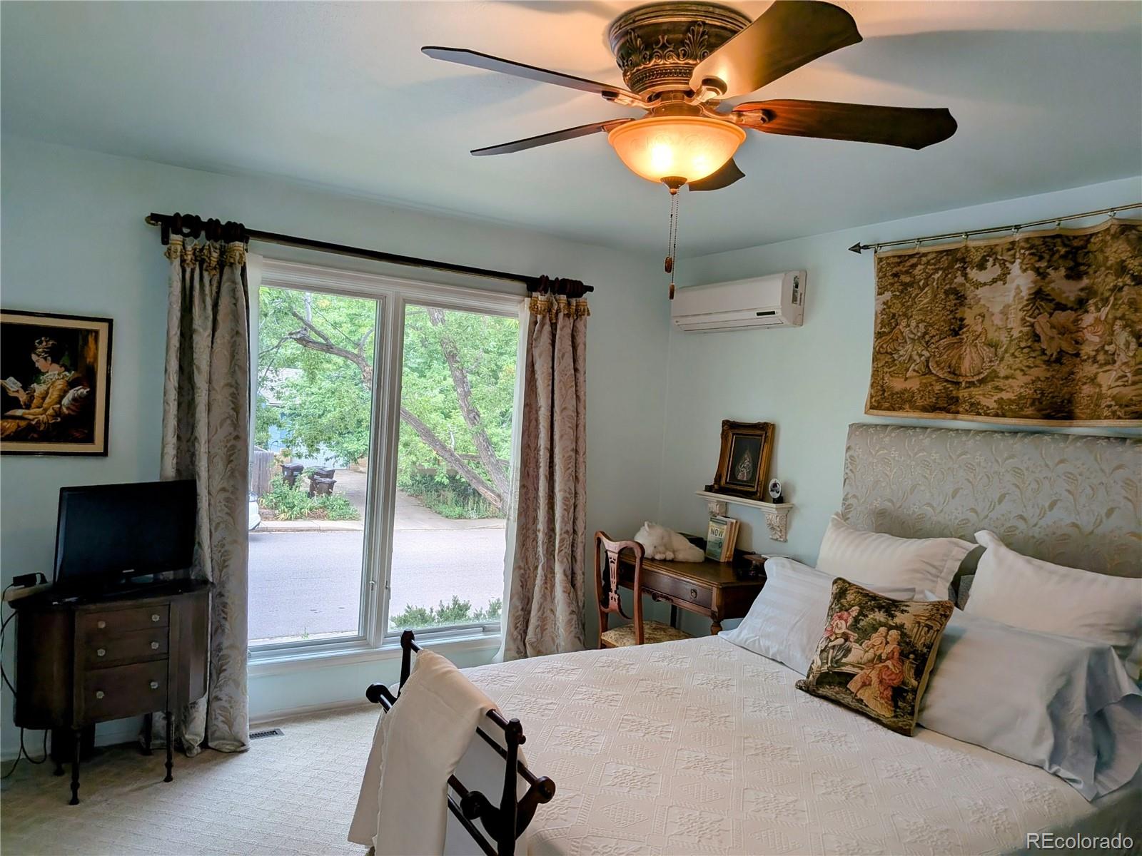 1080 Ithaca Drive Boulder, CO 80305 - Photo 26 of 35 a bedroom with a bed and a television