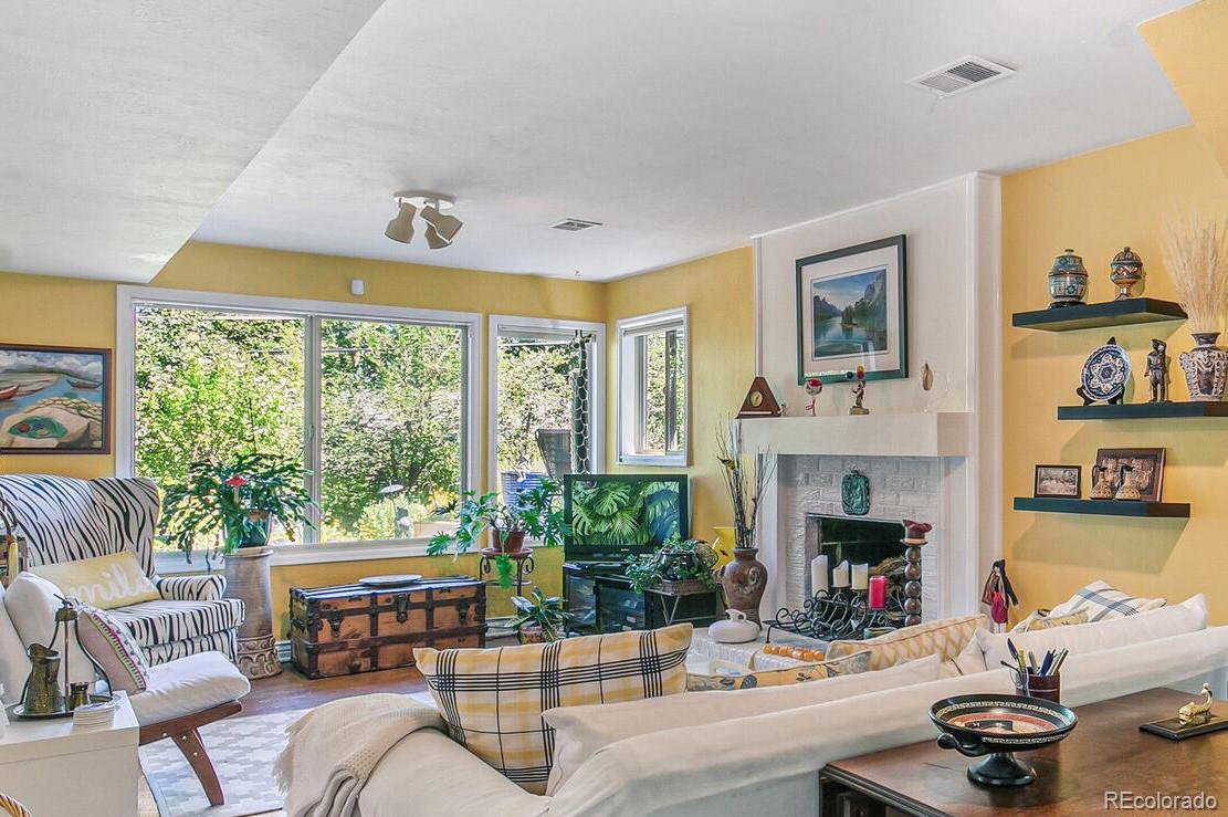 1080 Ithaca Drive Boulder, CO 80305 - Photo 29 of 35 a living room with furniture and a fireplace