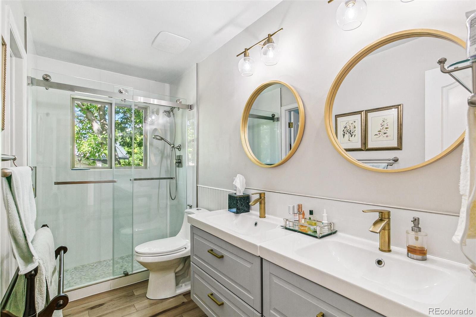 1080 Ithaca Drive Boulder, CO 80305 - Photo 31 of 35 a bathroom with a toilet a sink a mirror and a shower