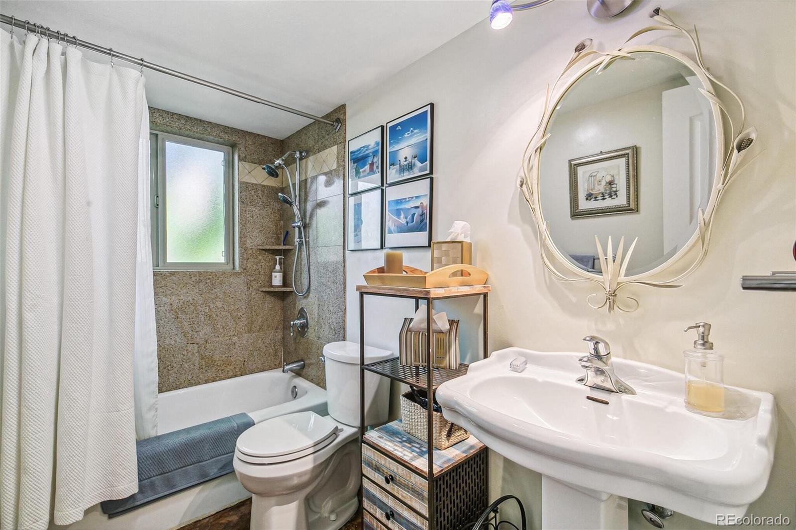 1080 Ithaca Drive Boulder, CO 80305 - Photo 32 of 35 a bathroom with a sink and mirror with toilet