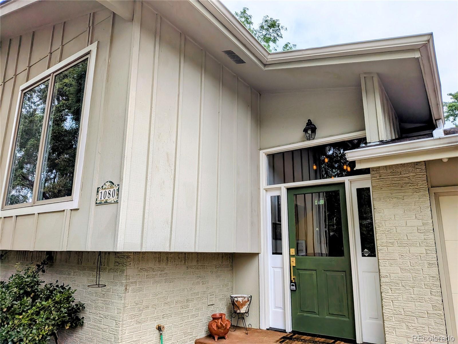 1080 Ithaca Drive Boulder, CO 80305 - Photo 4 of 35 a front view of a house with garage